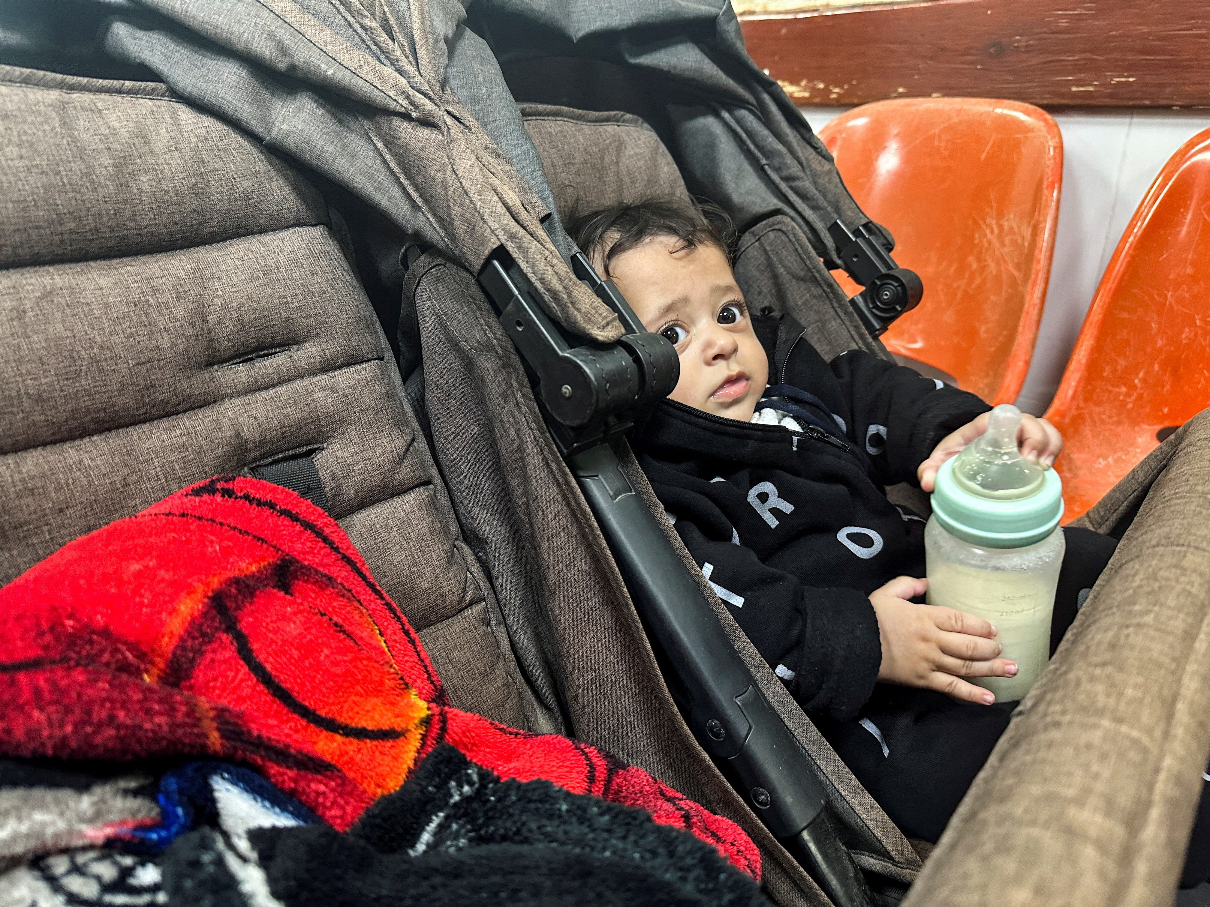 A Palestinian boy, who has a skin infection, looks on at a hospital, amid doctors warning of the spread of diseases and infections among Gazan children due to the ongoing conflict between Israel and Hamas, in Rafah, in the southern Gaza Strip.