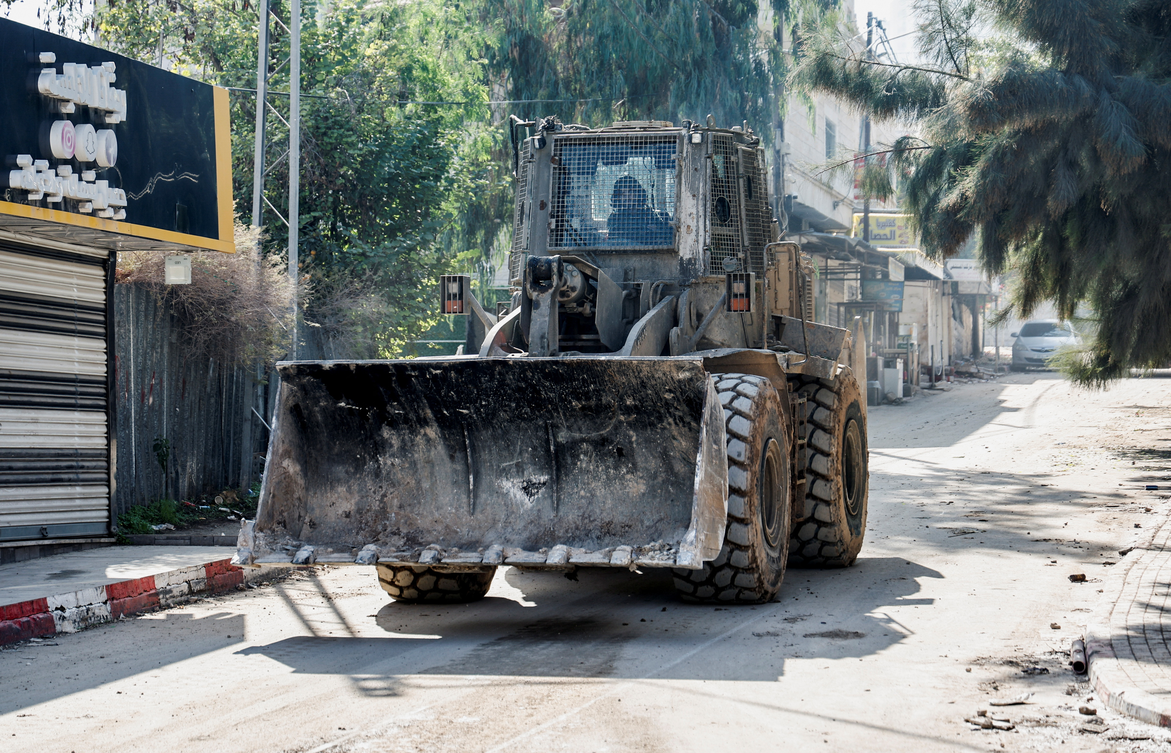An Israeli army bulldozer manoeuvres on a road during a raid in Jenin