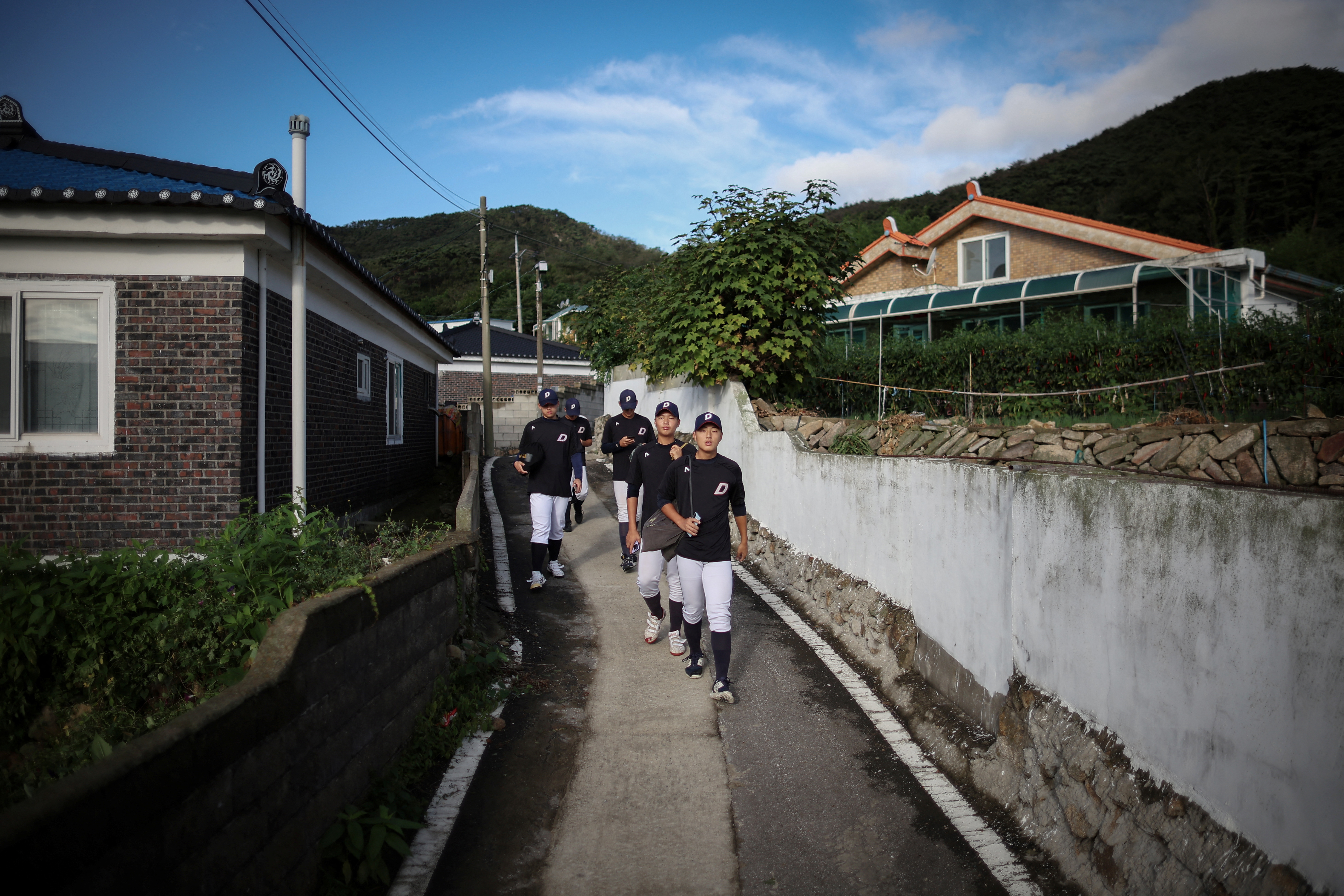 Members of the Deokjeok High School baseball team walk to school on Deokjeok island in Incheon, South Korea.
