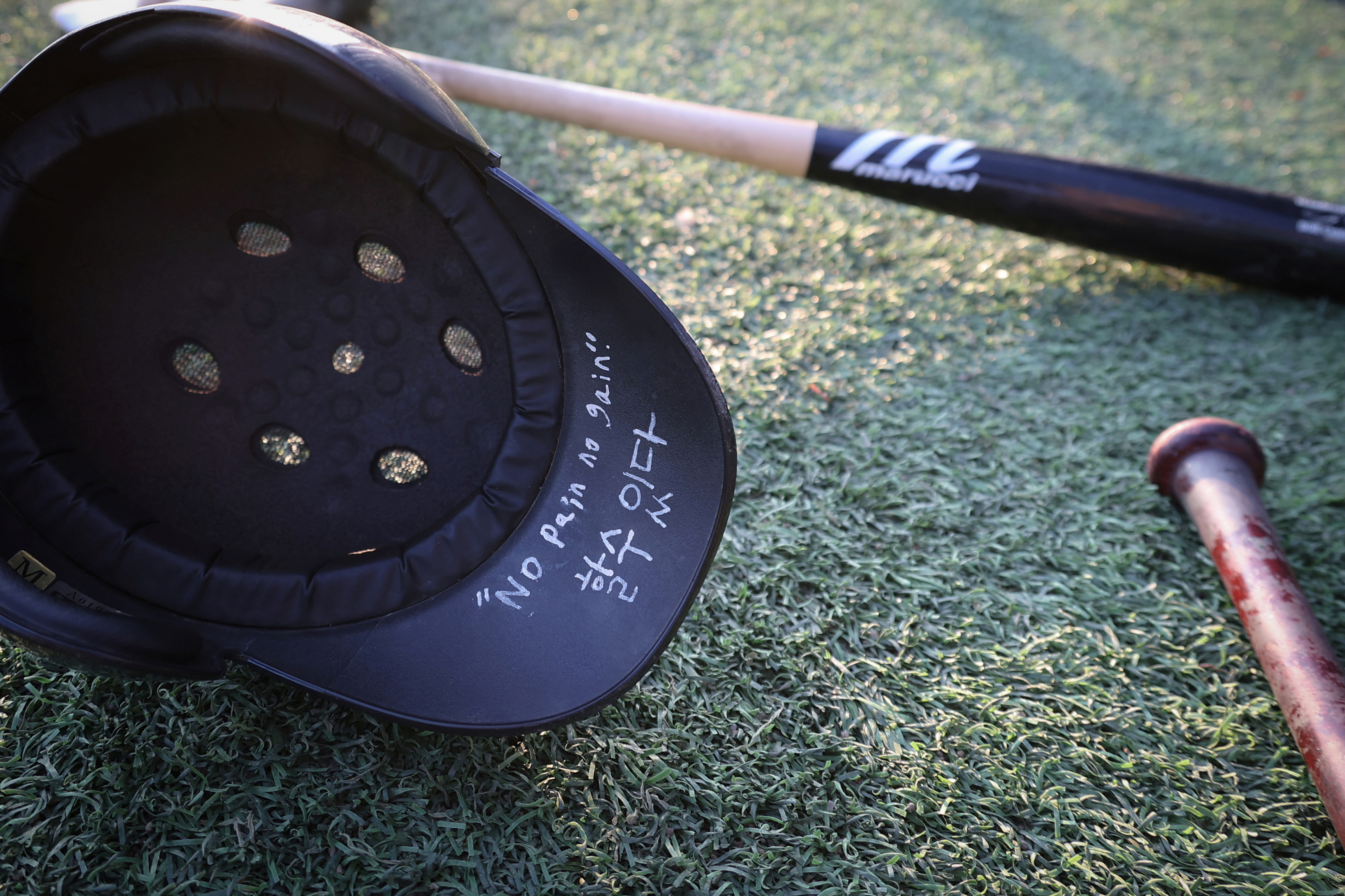 A message reading "No Pain No Gain" is written on a Deokjeok High School baseball team helmet, during their first game of the 51st Bonghwang High School Baseball Tournament in Seoul, South Korea.