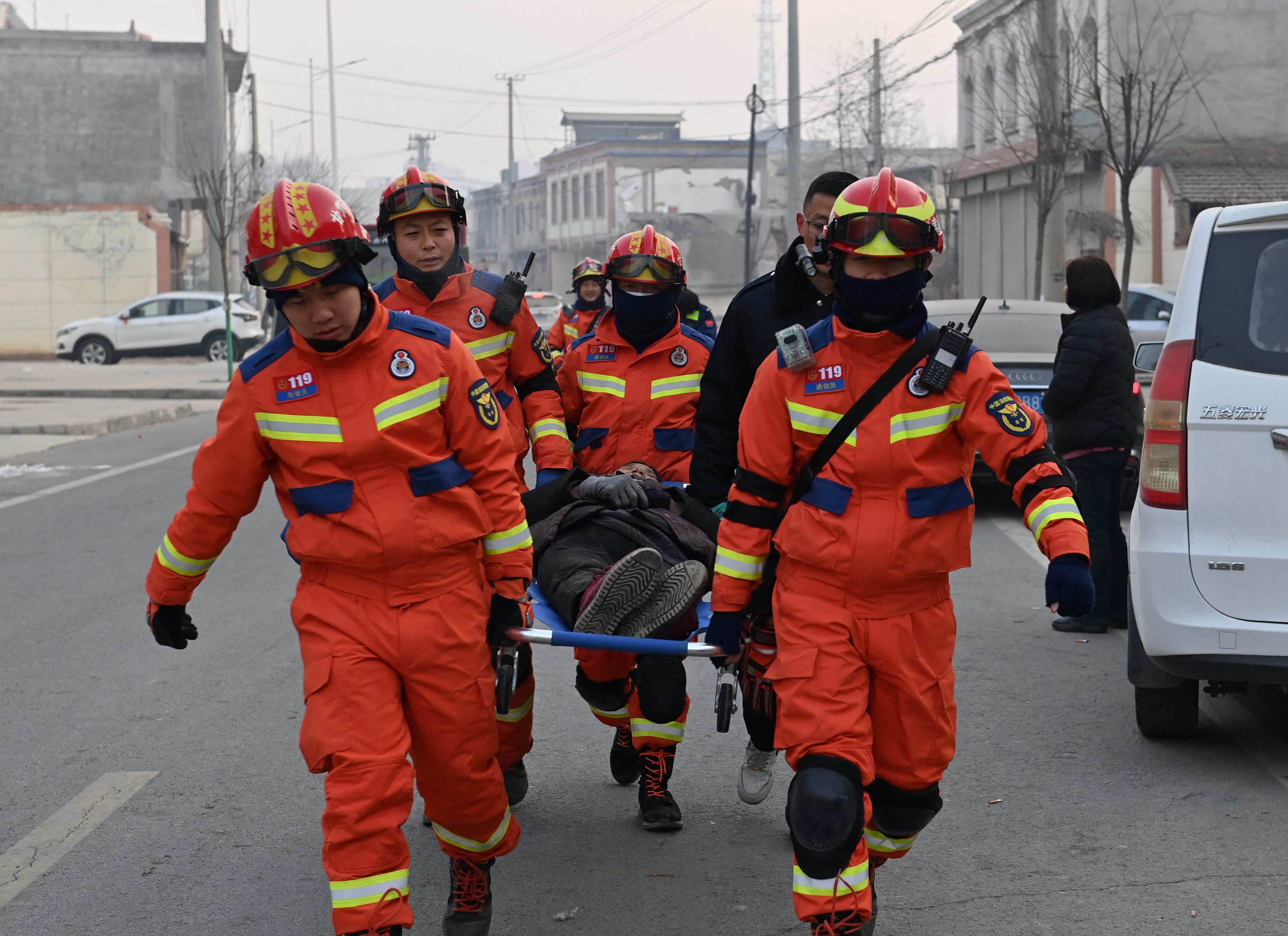 Rescue workers carry an injured person