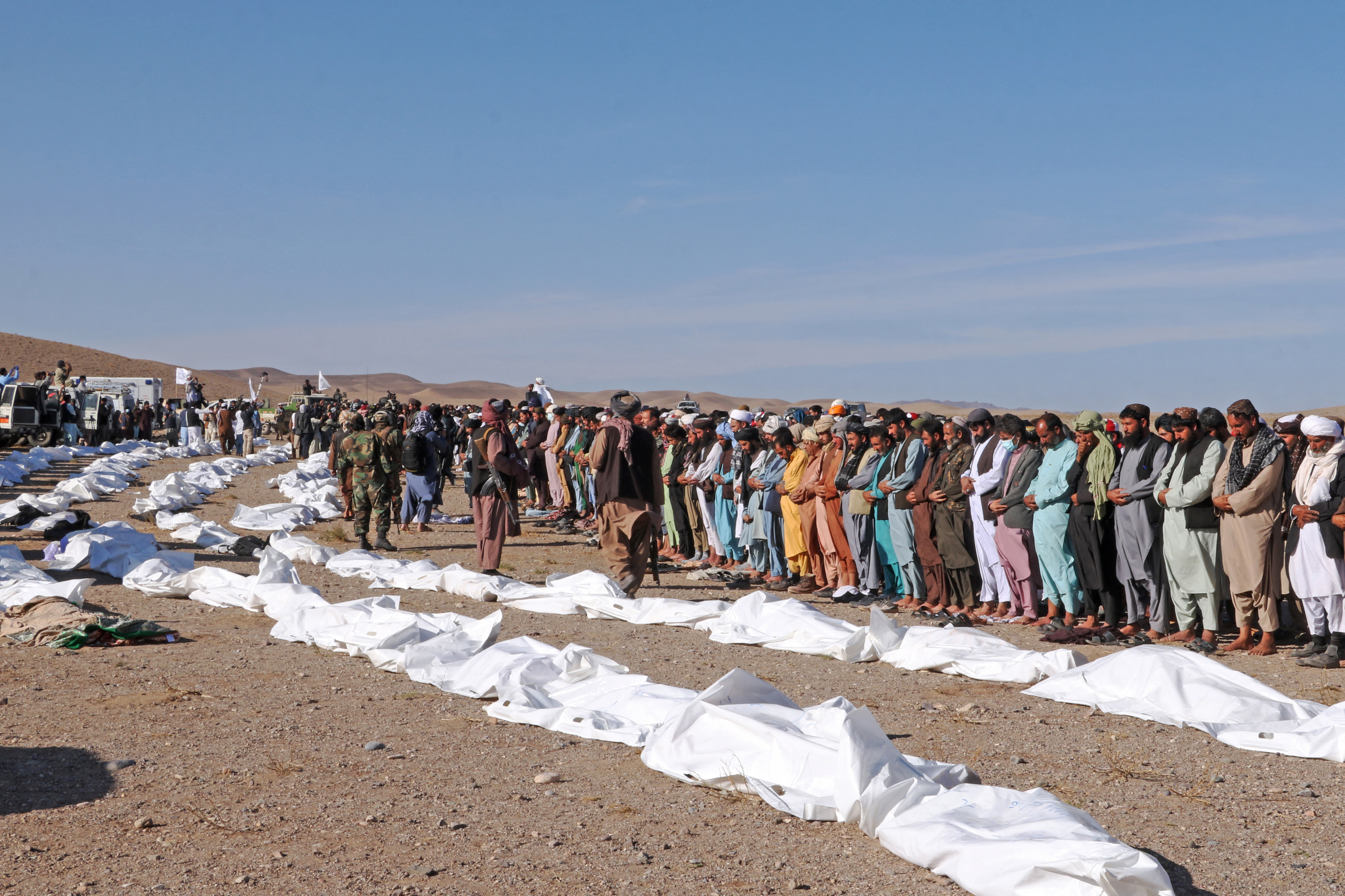 Afghan mourners offer mass funeral prayers for the people killed in a series of earthquakes in Zendeh Jan district of Herat province.