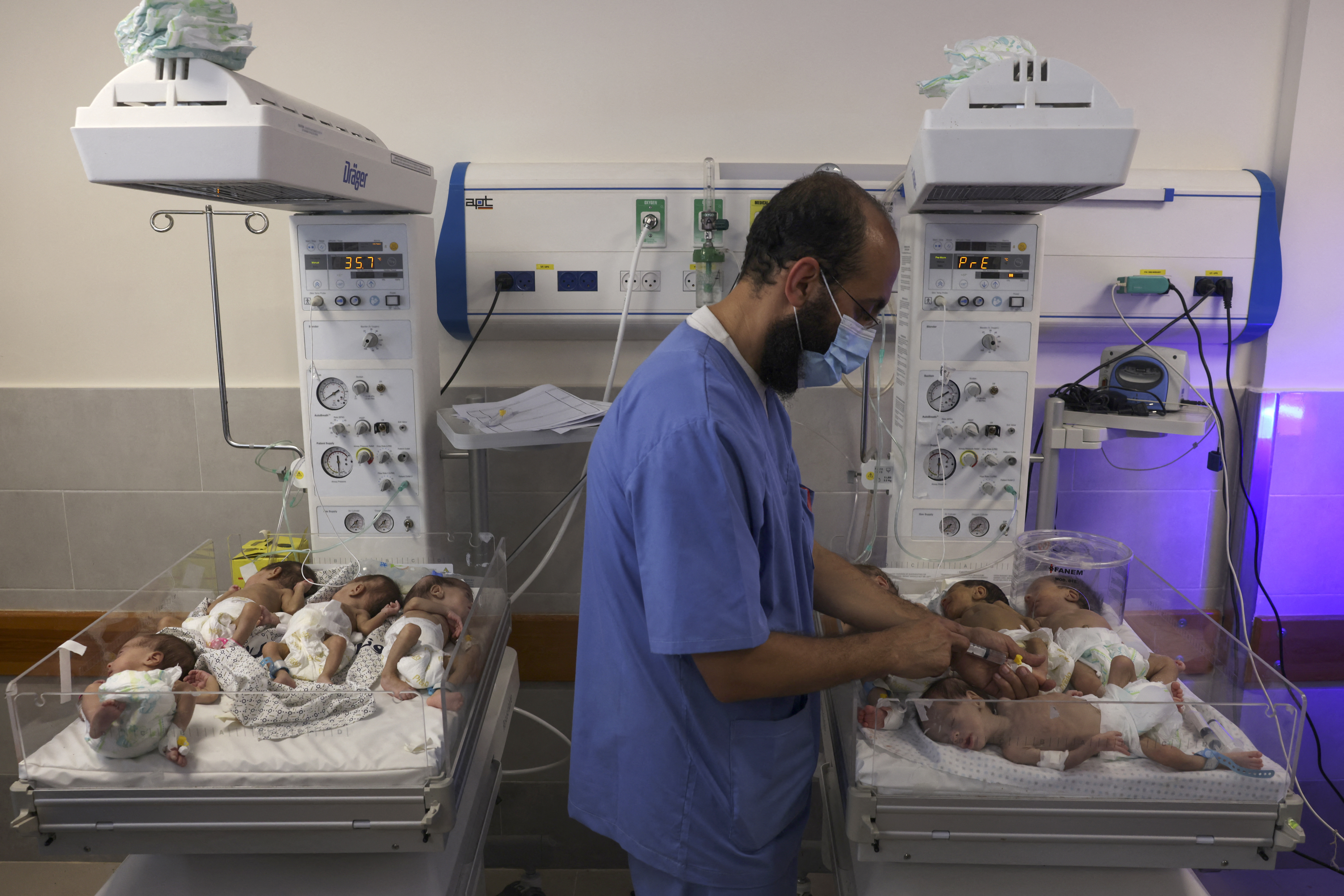 A Palestinian medic cares for premature babies evacuated from Al Shifa hospital to the Emirates hospital in Rafah in the southern Gaza Strip, on November 19, 2023.