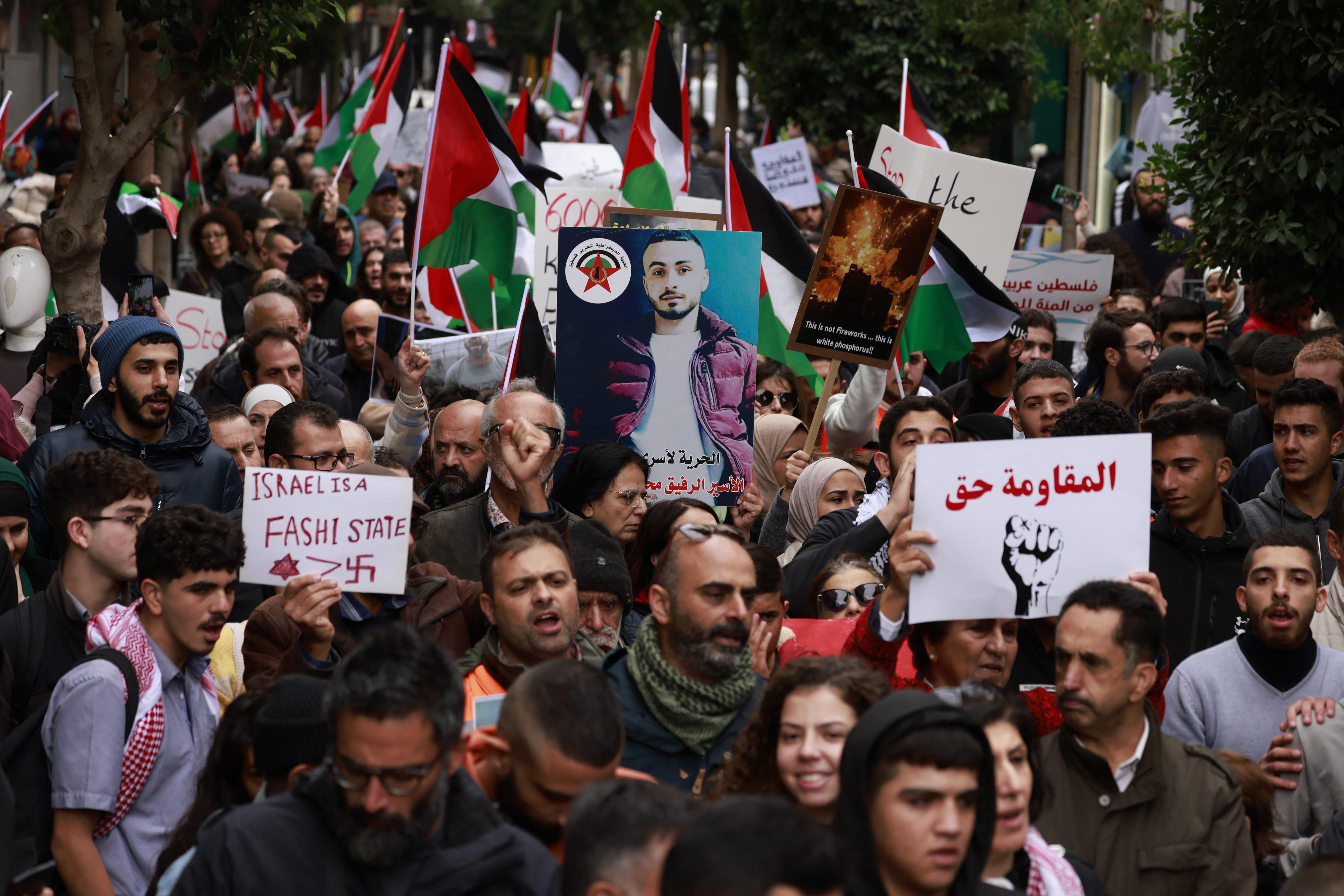 Palestinians march to express their solidarity with the Gaza Strip in the occupied West Bank city of Ramallah on November 22.