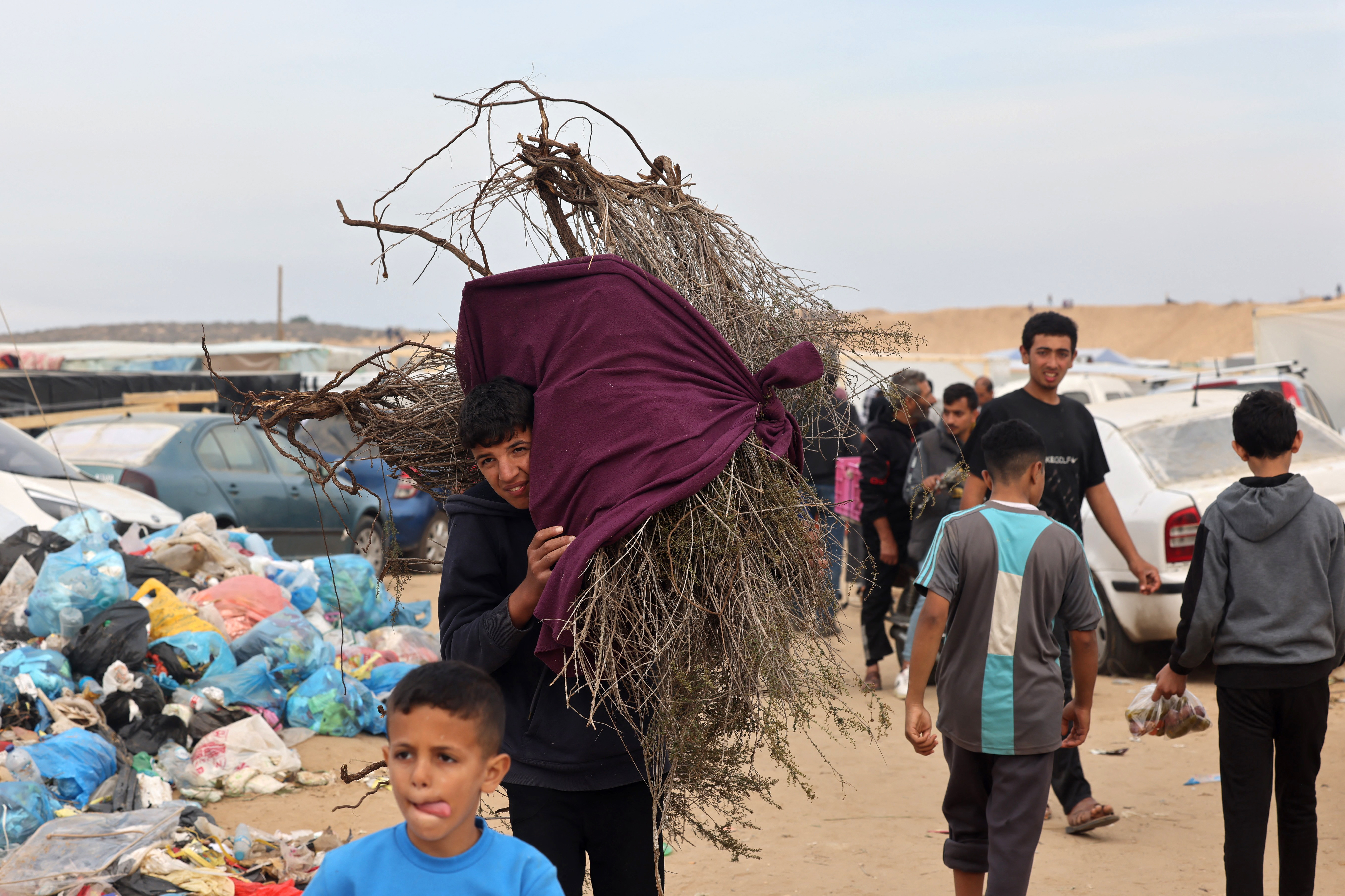 A boy carries wood for heating and cooking in Rafah in the southern Gaza Strip.