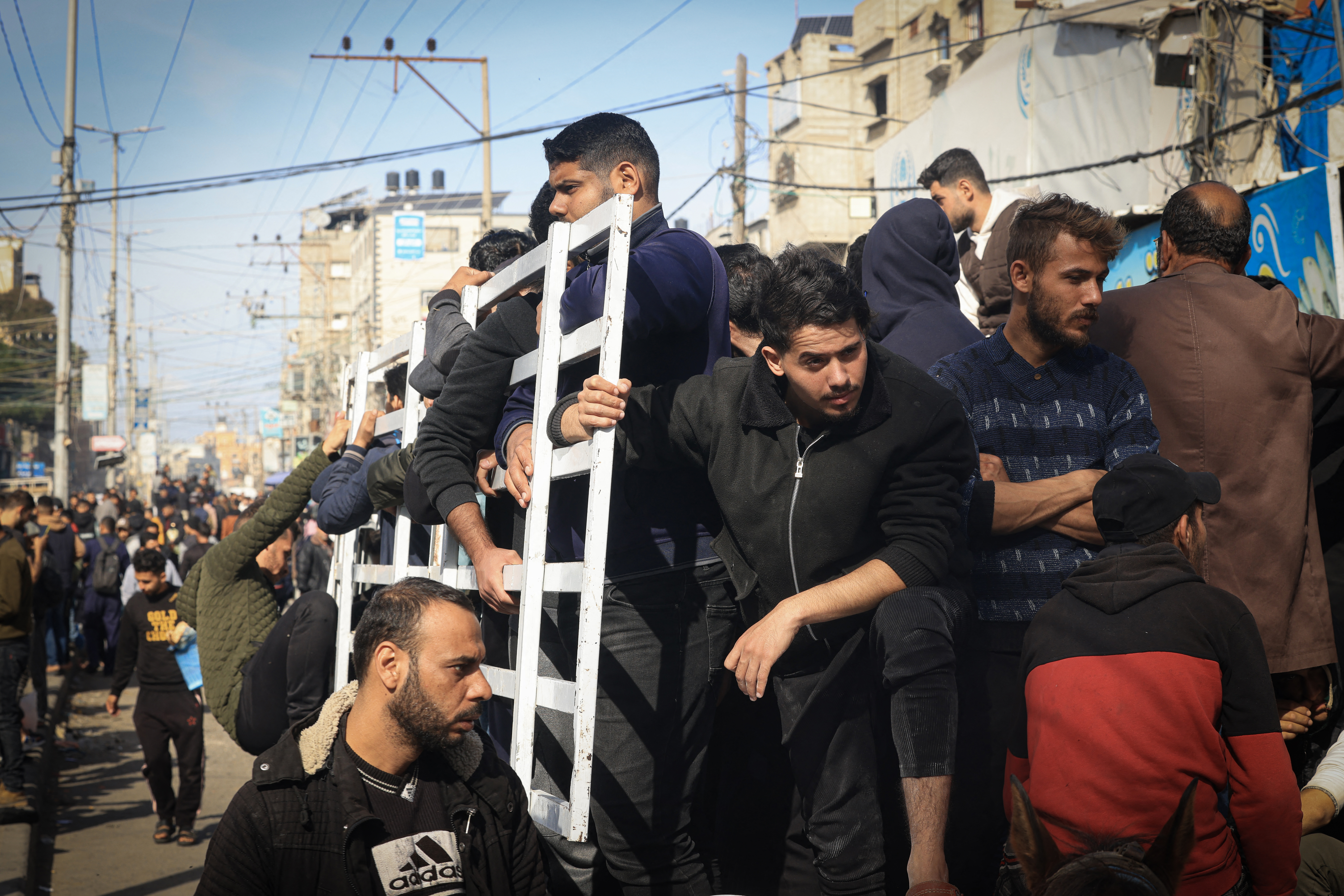 Palestinians crowd a street in Rafah in the southern Gaza Strip on December 9