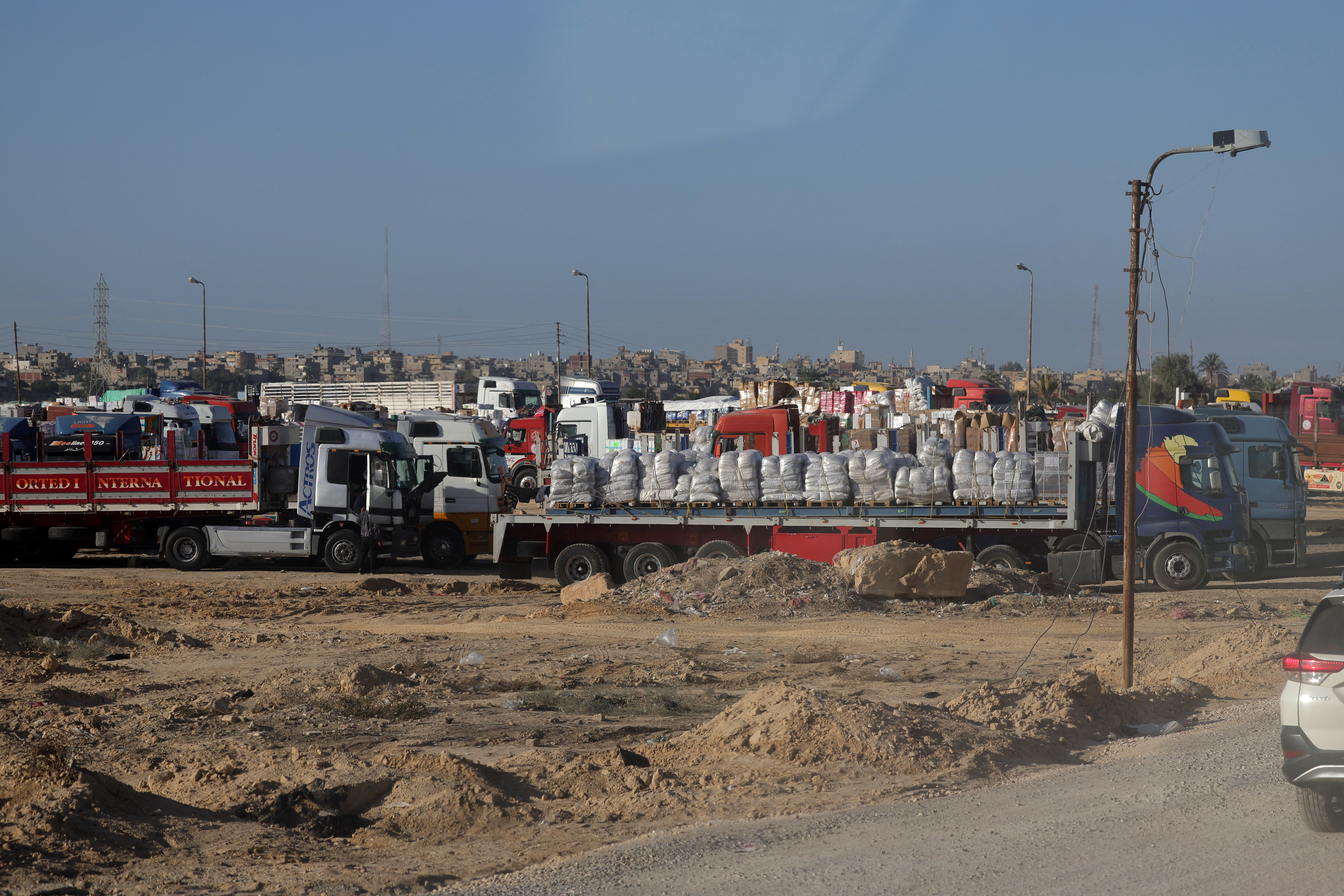 Trucks with humanitarian aid wait to enter the Palestinian side of Rafah on the Egyptian border with the Gaza Strip.