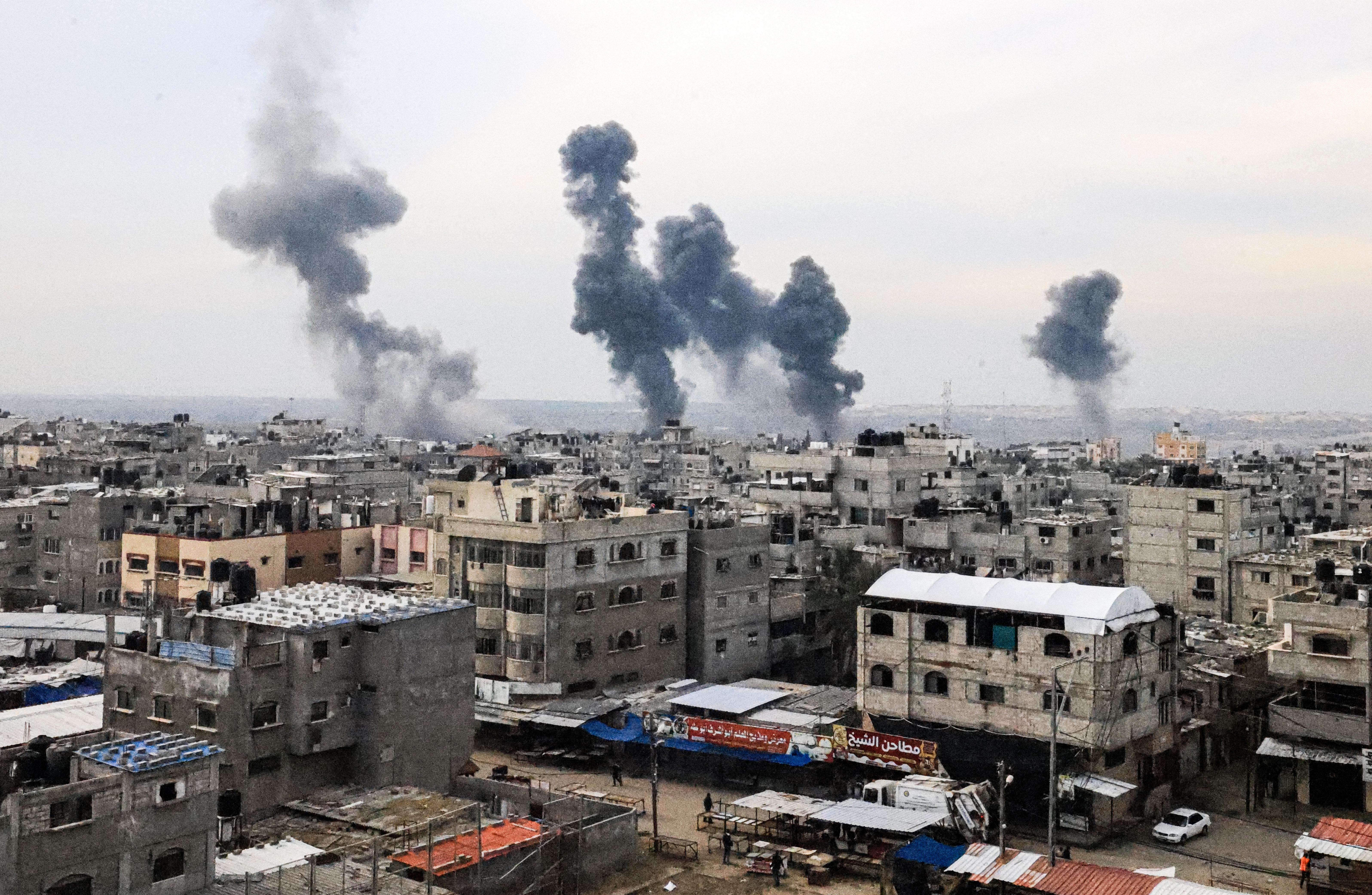 A picture taken on December 20, 2023, from Rafah shows smoke billowing after Israeli strikes over the Nuseirat refugee camp in the central Gaza Strip.