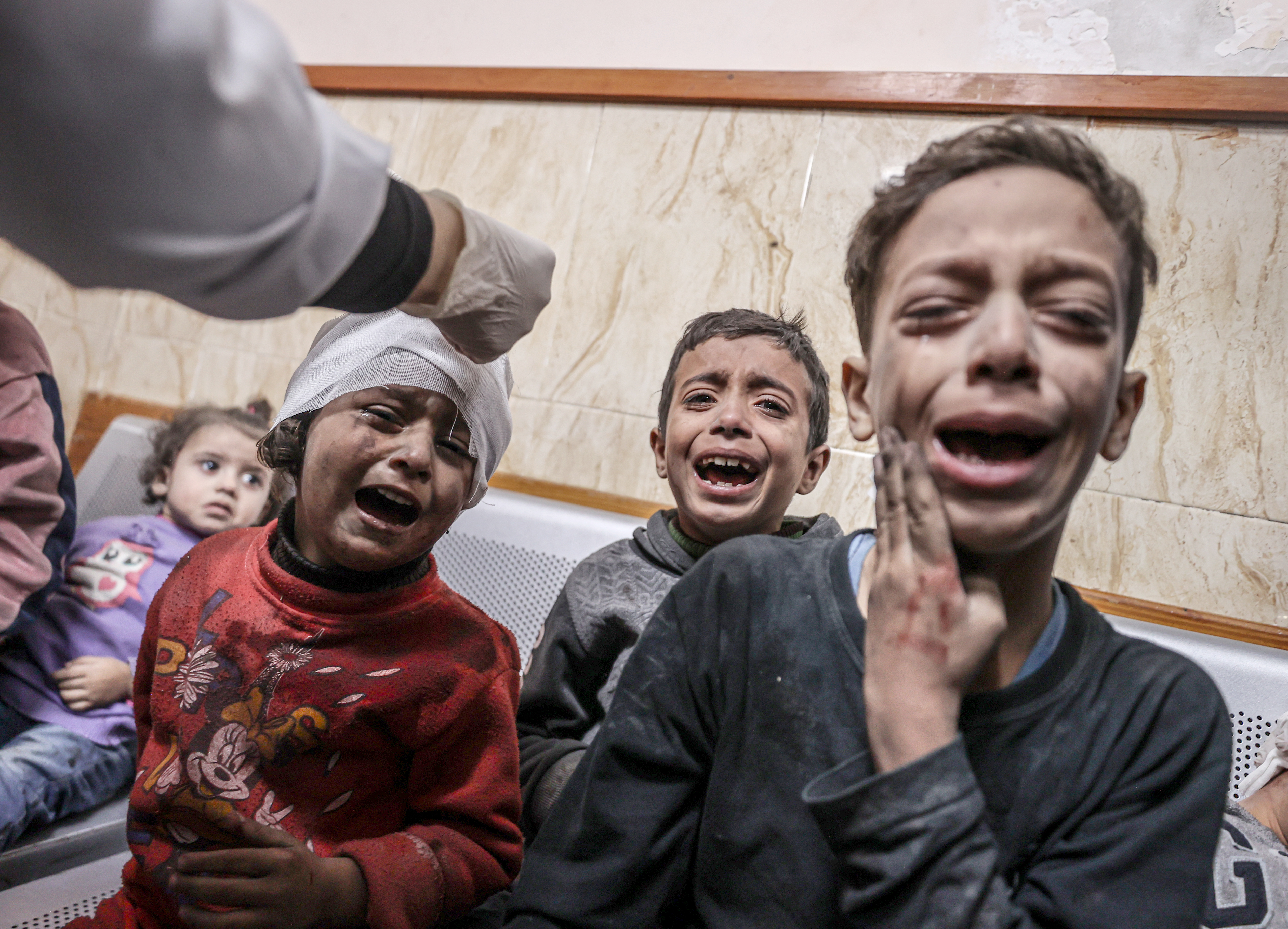 Injured people, including children, are brought to Al-Aqsa Martyrs Hospital for treatment after an Israeli attack following the humanitarian pause between Israel and Palestinian resistance group Hamas in Deir al-Balah, Gaza on December 02