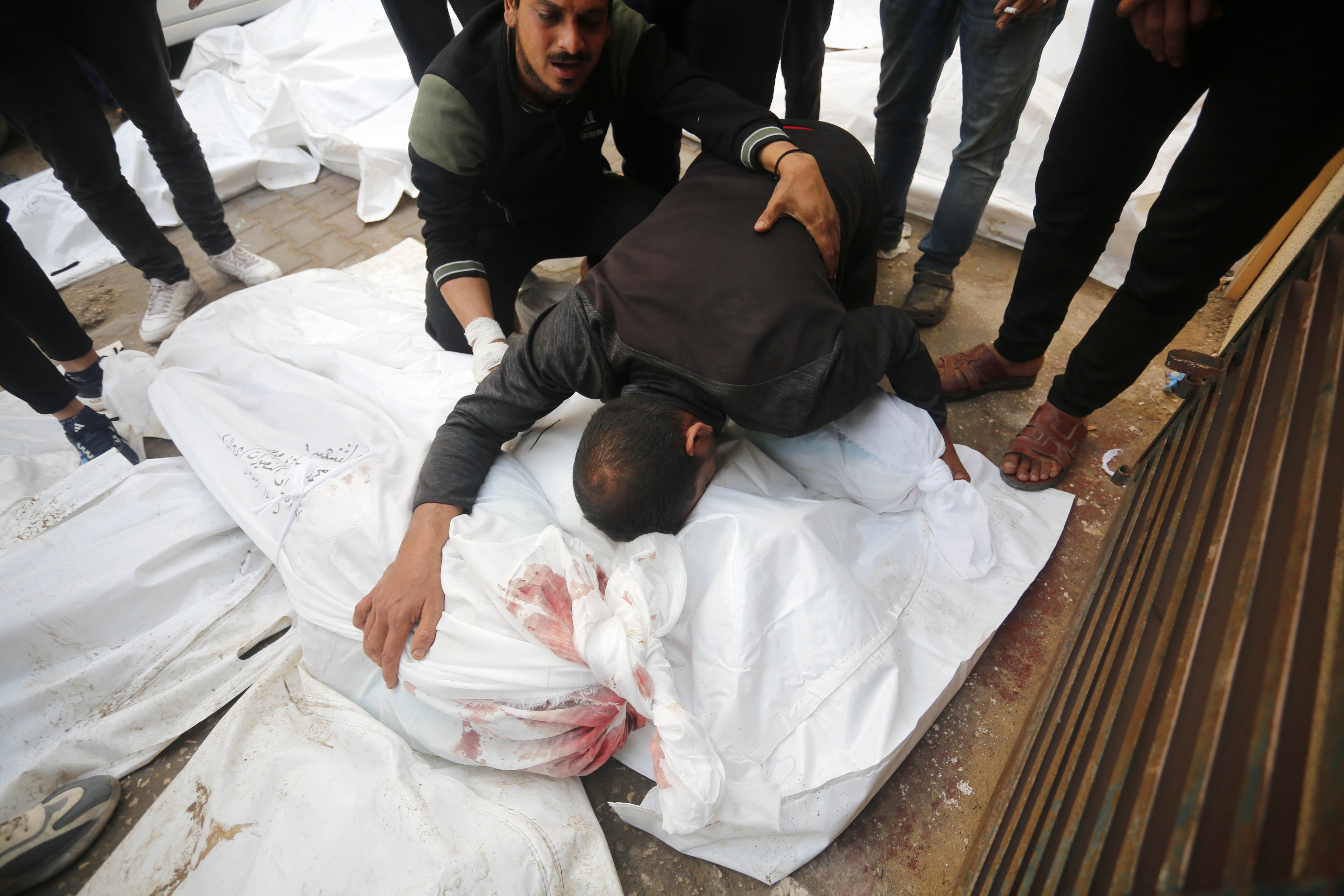 Relatives of the dead Palestinians mourn at the Al-Aqsa Martyrs Hospital as the Israeli attacks continue in Deir Al-Balah, Gaza.