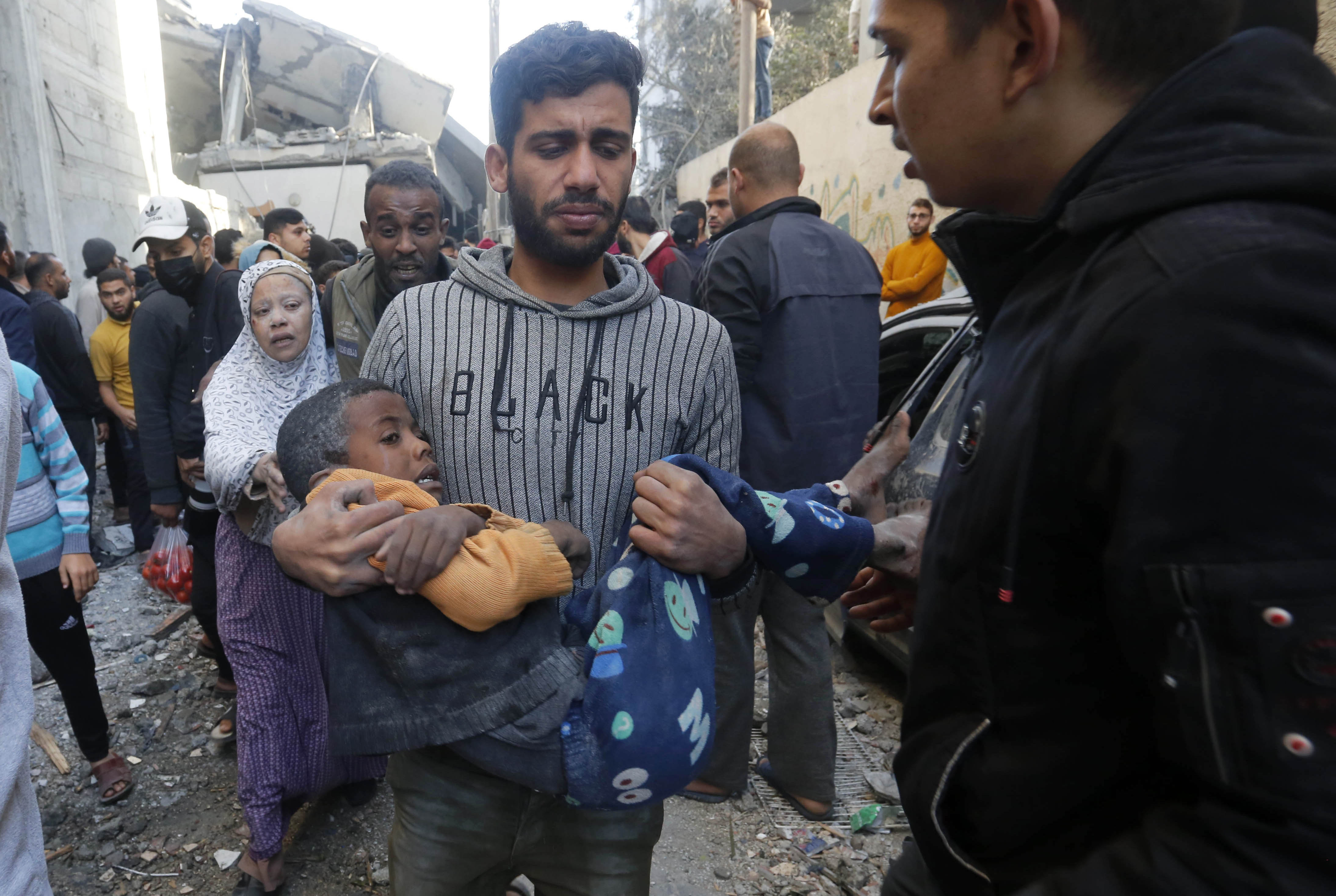 A Palestinian boy is saved as the residents and civil defense teams conduct a search and rescue operation among demolished buildings after Israeli attacks in Deir Al-Balah, Gaza.