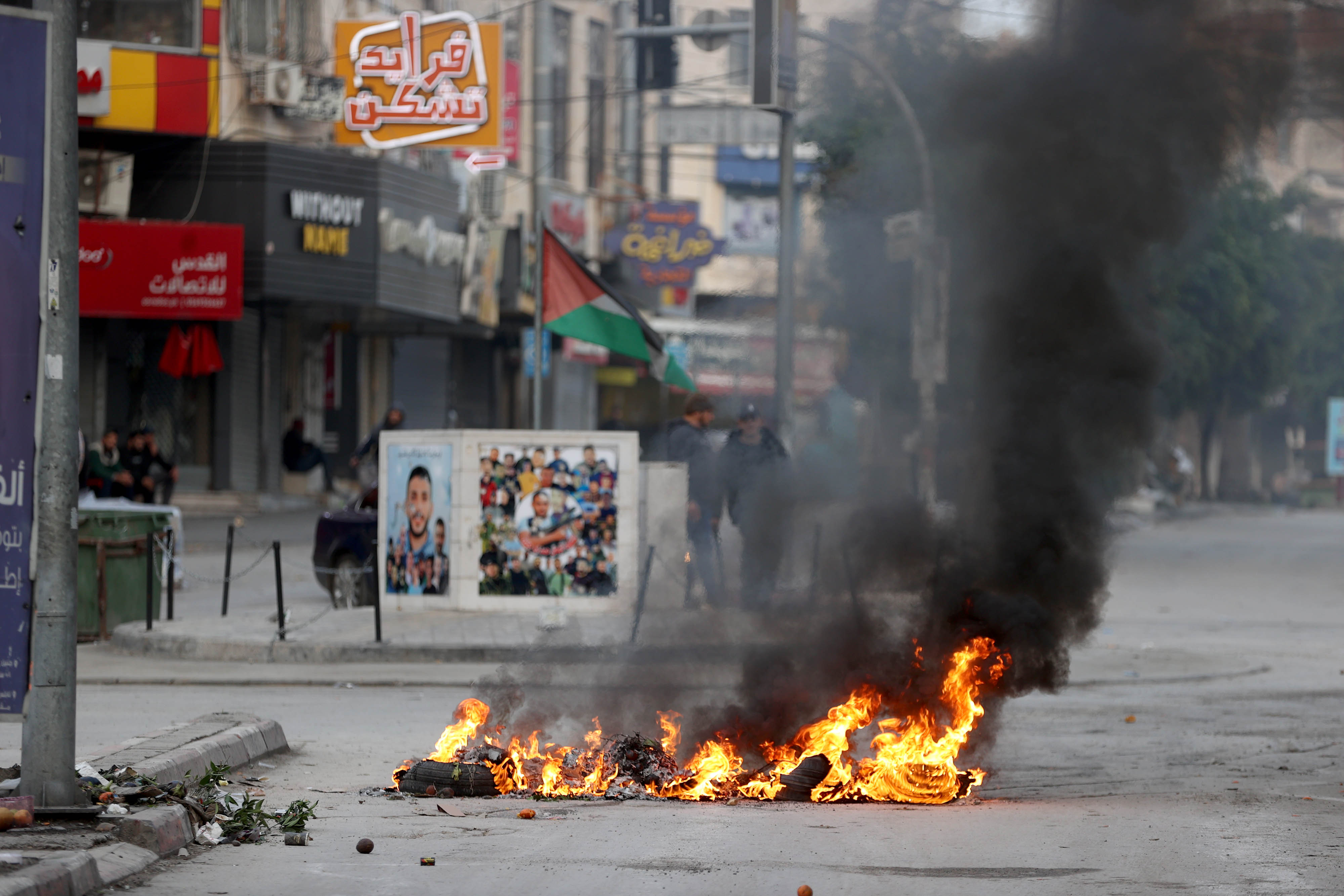 Car tires are burned as Israeli forces raid the Jenin Refugee Camp in the city of Jenin, north of the West Bank.