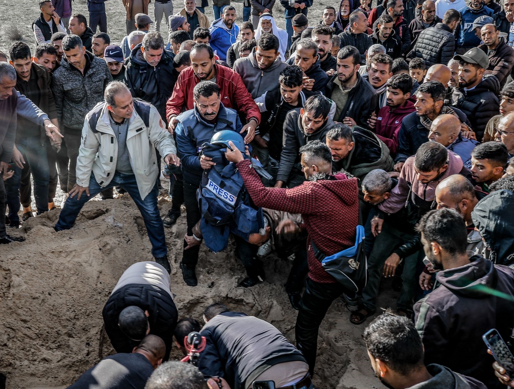People attend the funeral ceremony of Al Jazeera cameraman Samir Abu Dhaka, who died in the Israeli attacks in Khan Yunis, Gaza on December 16