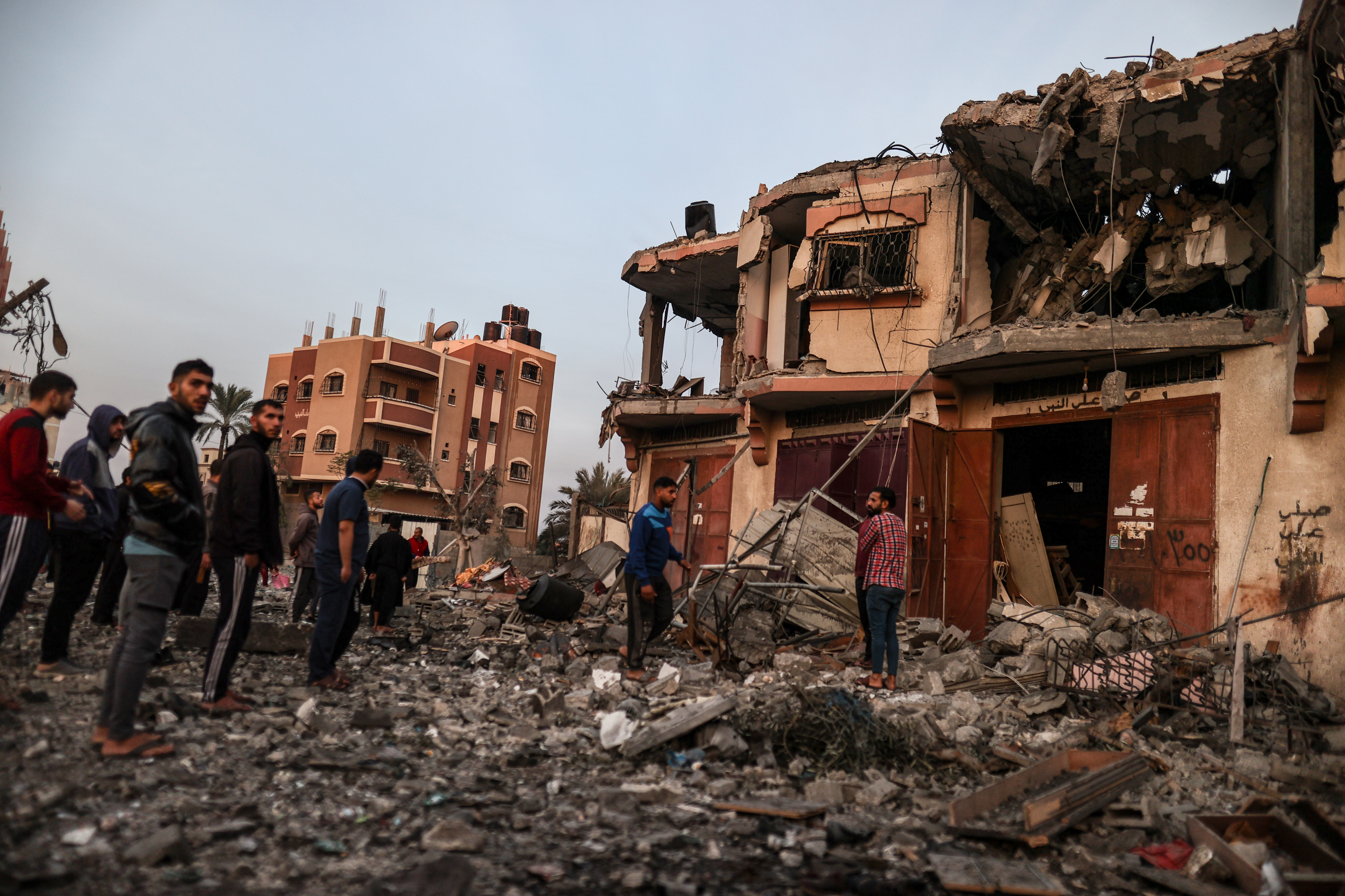 Residents and civil defense teams conduct search and rescue operation around the rubble of the building following an Israeli attack on house belonging to Misri family in Deir al-Balah, Gaza.