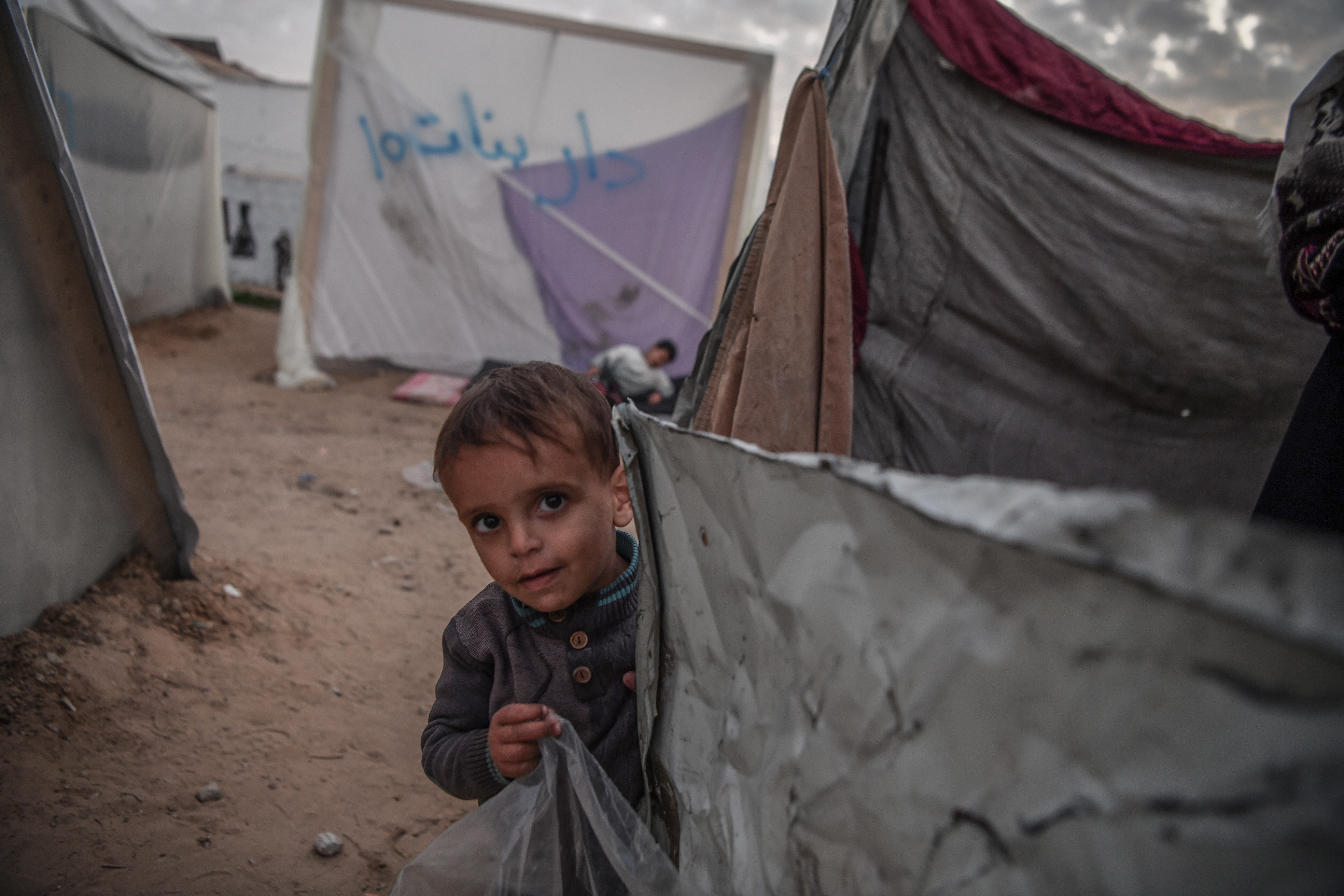 Palestinians are seen around their makeshift tents as they left their homes and took refuge in Rafah city in order to protect themselves from Israeli attacks and to ensure their safety in Rafah.