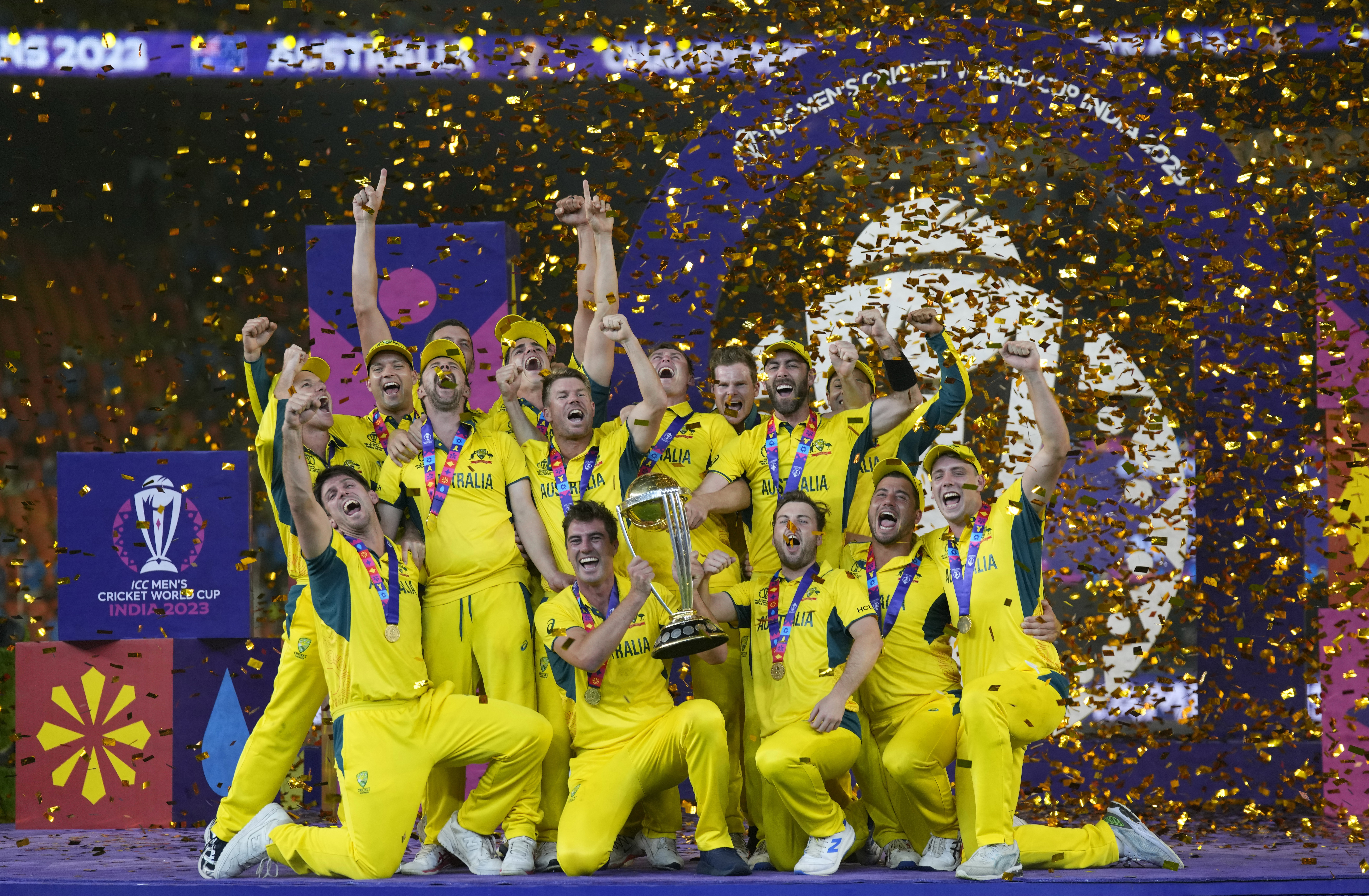 Australian players celebrate with the trophy after winning against India during the ICC Men's Cricket World Cup final match in Ahmedabad, India