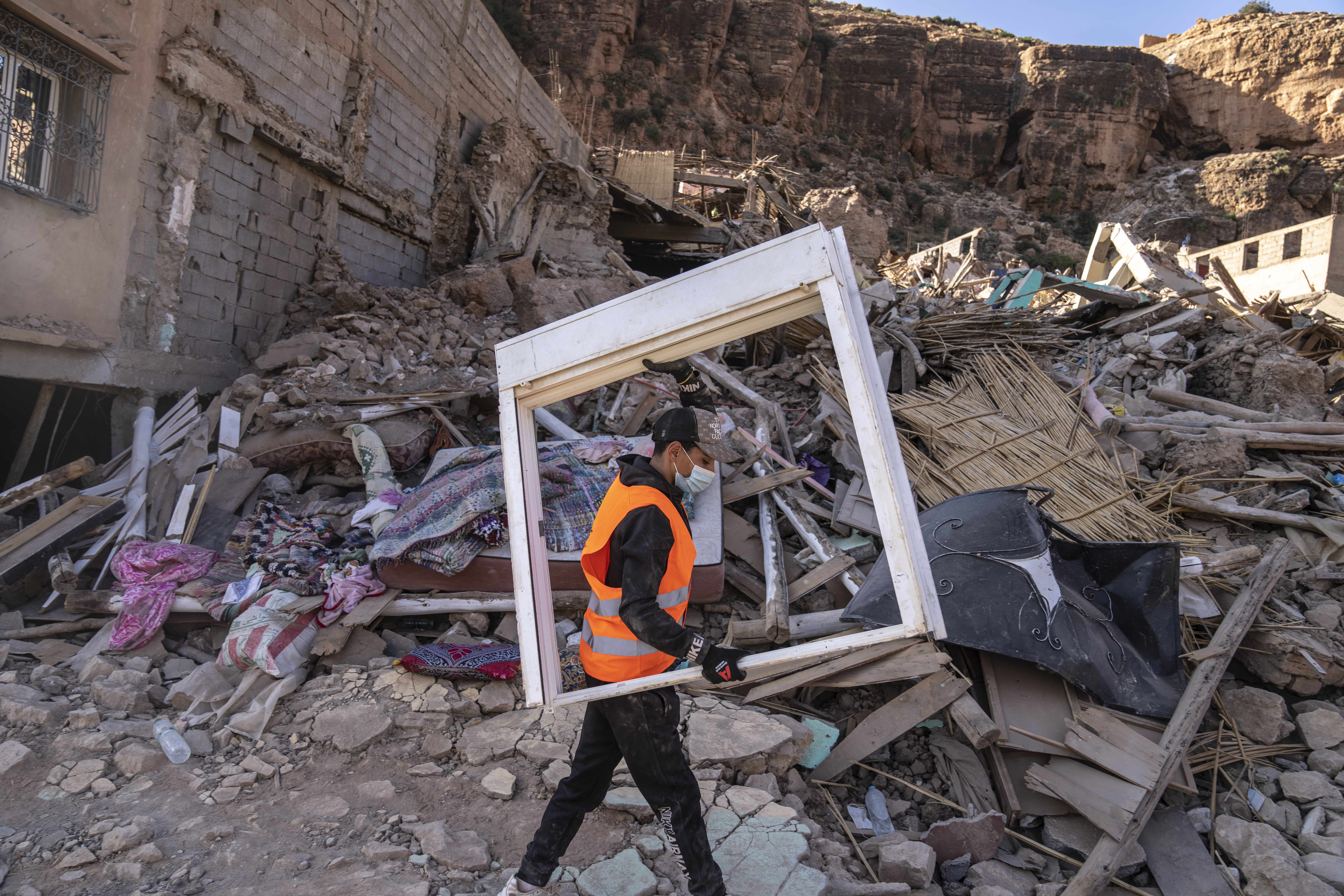 A volunteer helps salvage furniture from homes which were damaged by the earthquake, in the town of Imi N'tala, outside Marrakech, Morocco.