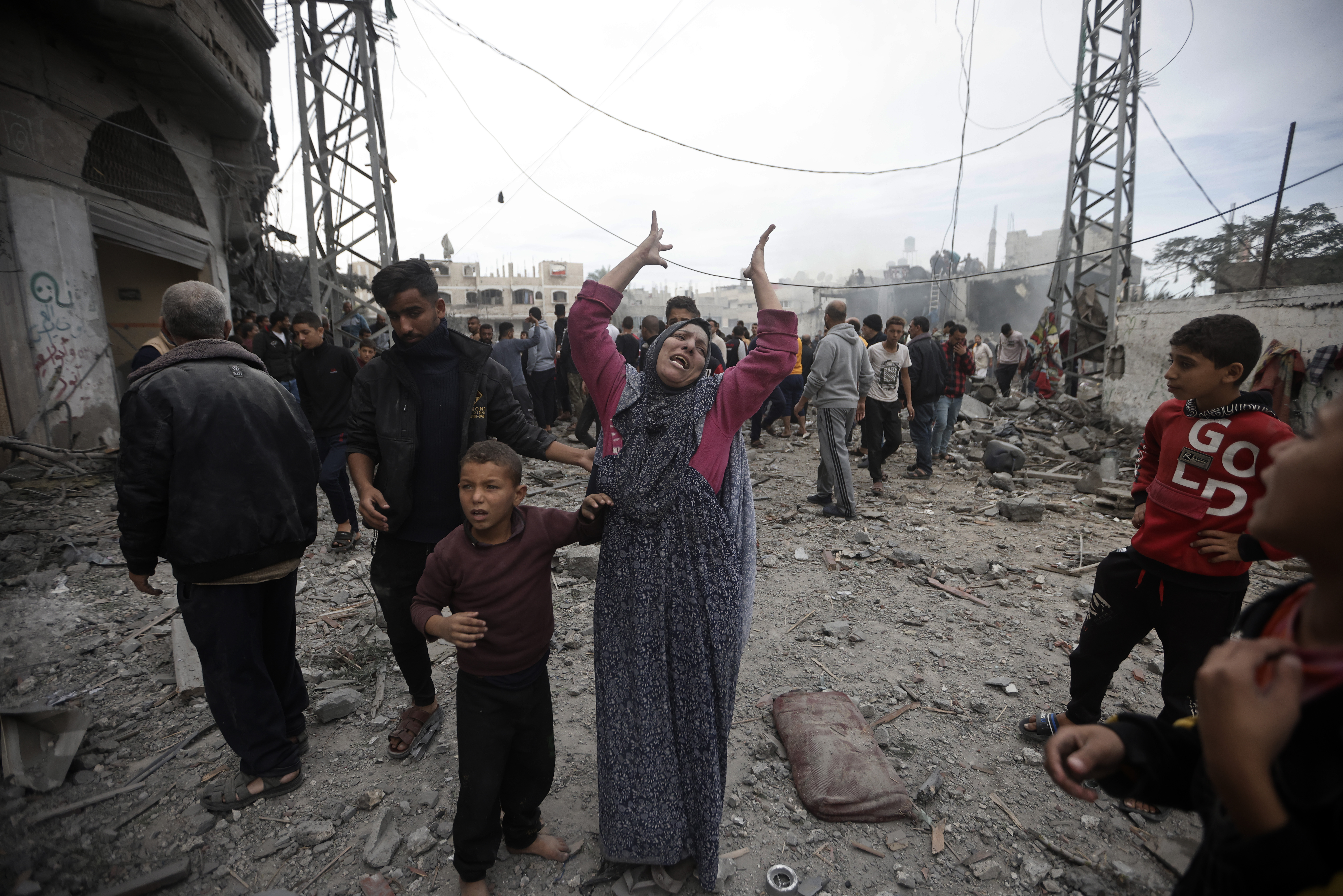 A Palestinian woman gestures following Israeli airstrikes in Khan Younis refugee camp, southern Gaza Strip.