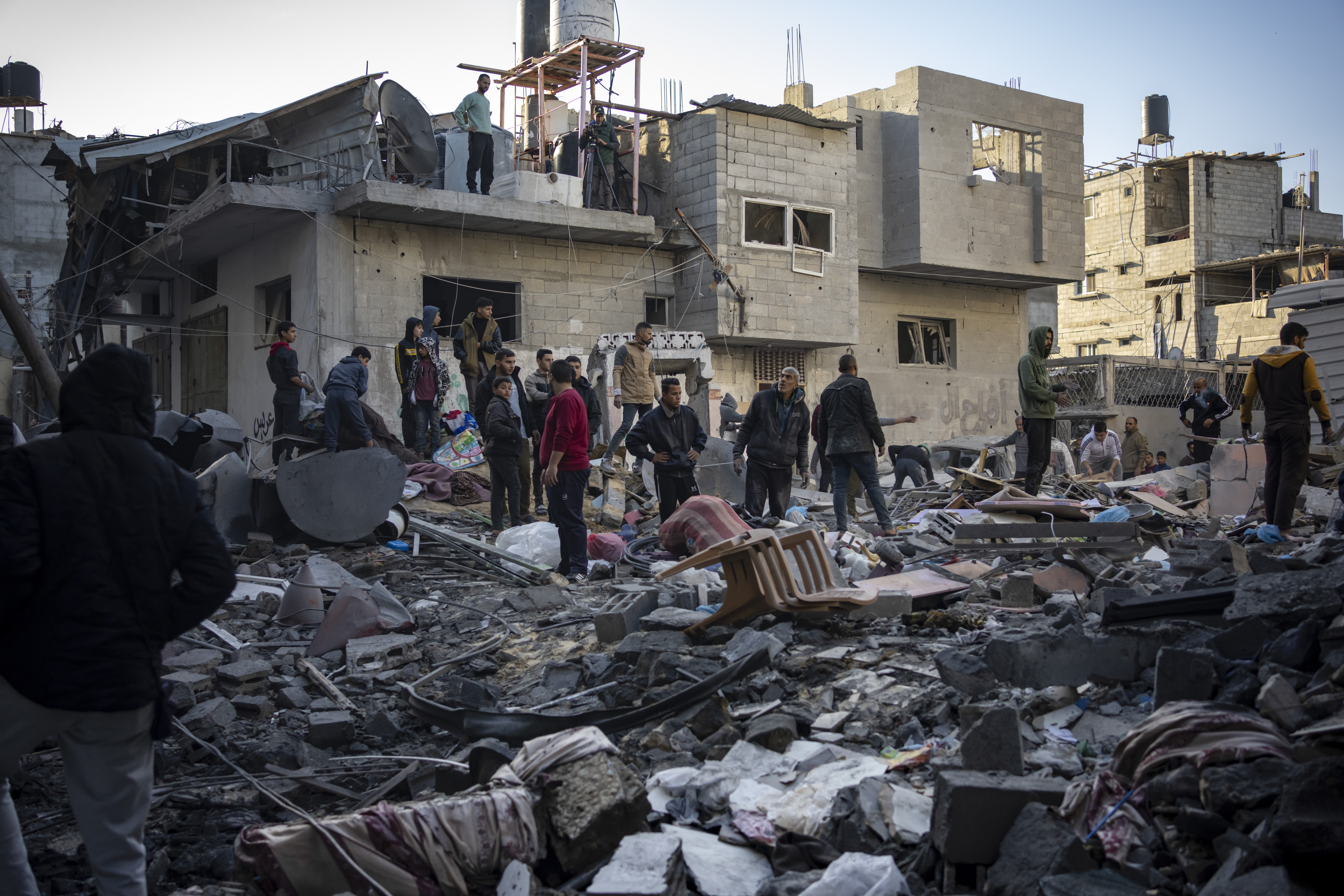 Palestinians look at houses destroyed in the Israeli bombardment of the Gaza Strip in Rafah.