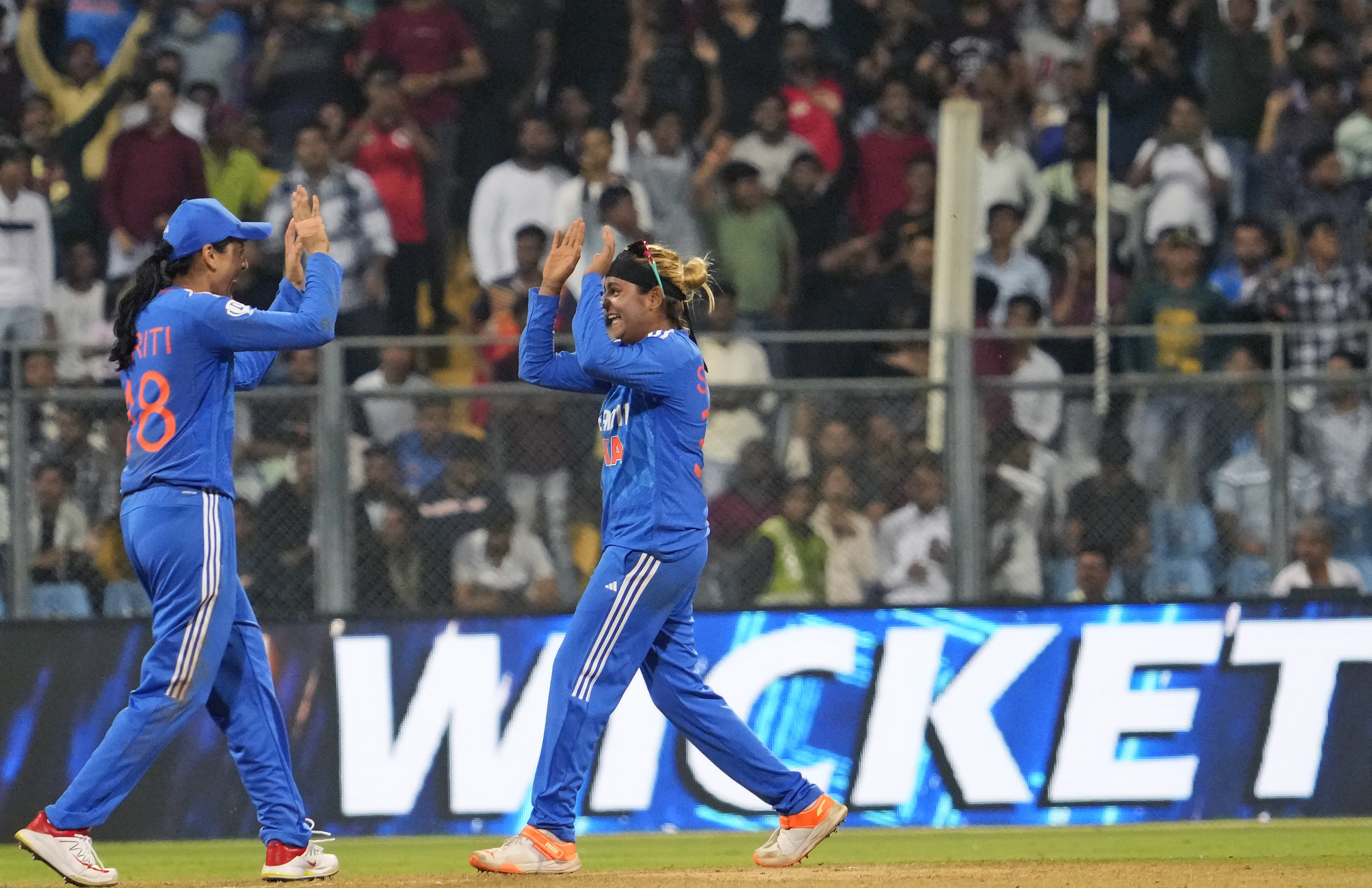 India's Saika Ishaque, right, celebrates the wicket of England's Amy Jones during the third and final T20 women's cricket match between England and India in Mumbai, India, Sunday, Dec. 10, 2023. (AP Photo /Rajanish Kakade)