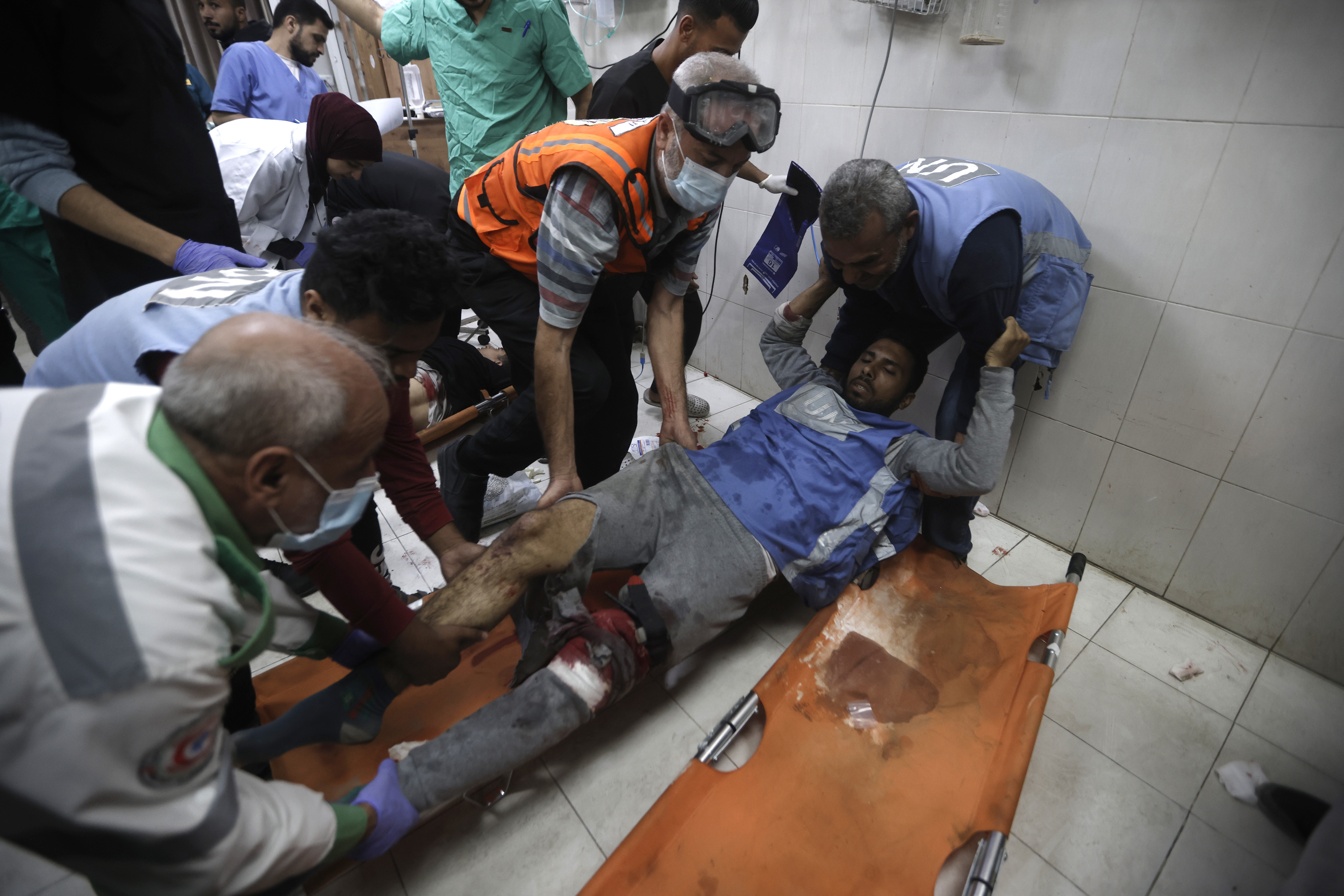 A United Nations worker wounded in Israeli airstrikes on a U.N.-run school arrives at the Nasser hospital in the town of Khan Younis, southern Gaza Strip.