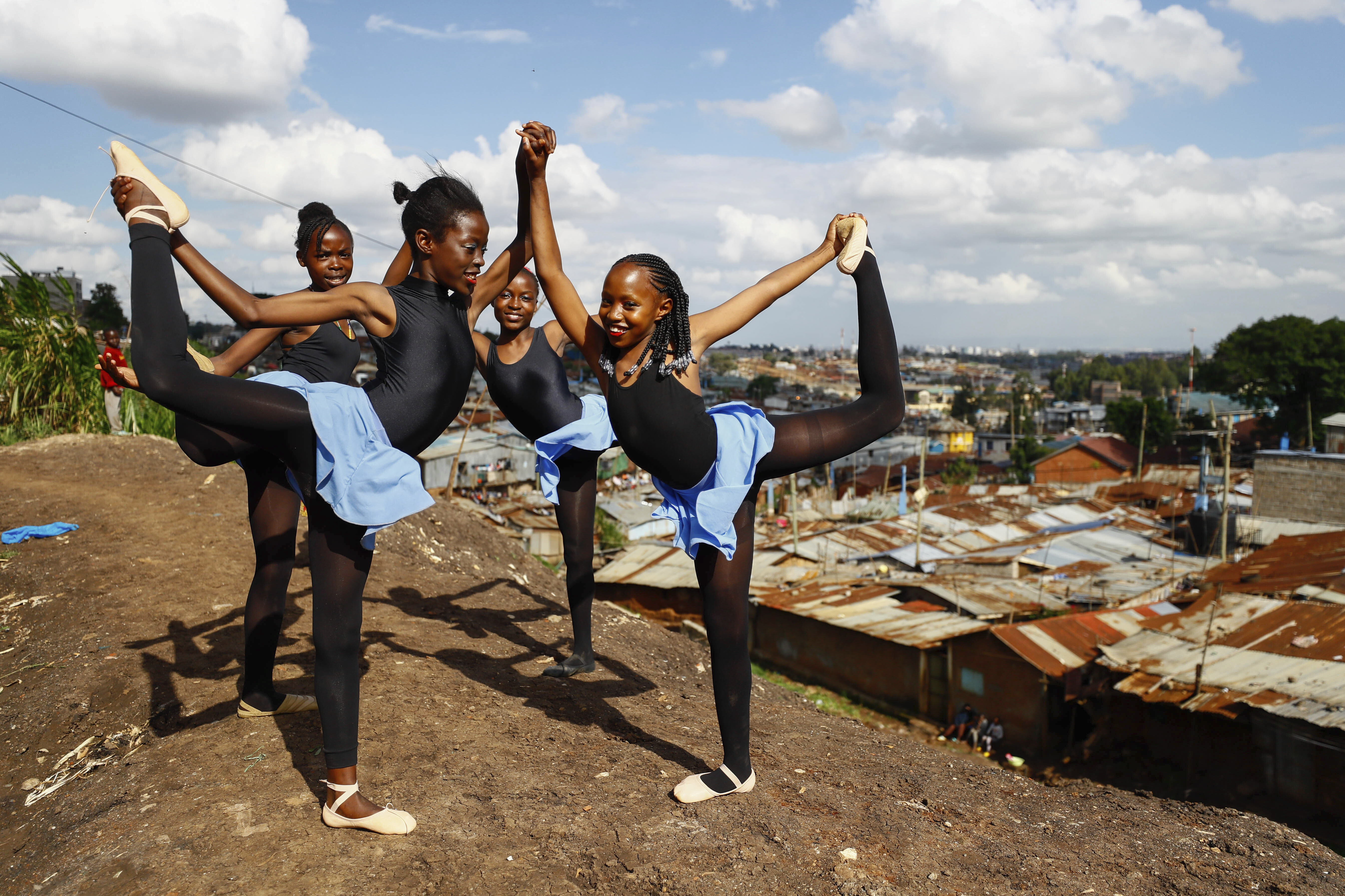 Young dancers practice by the Kenya - Uganda railway line