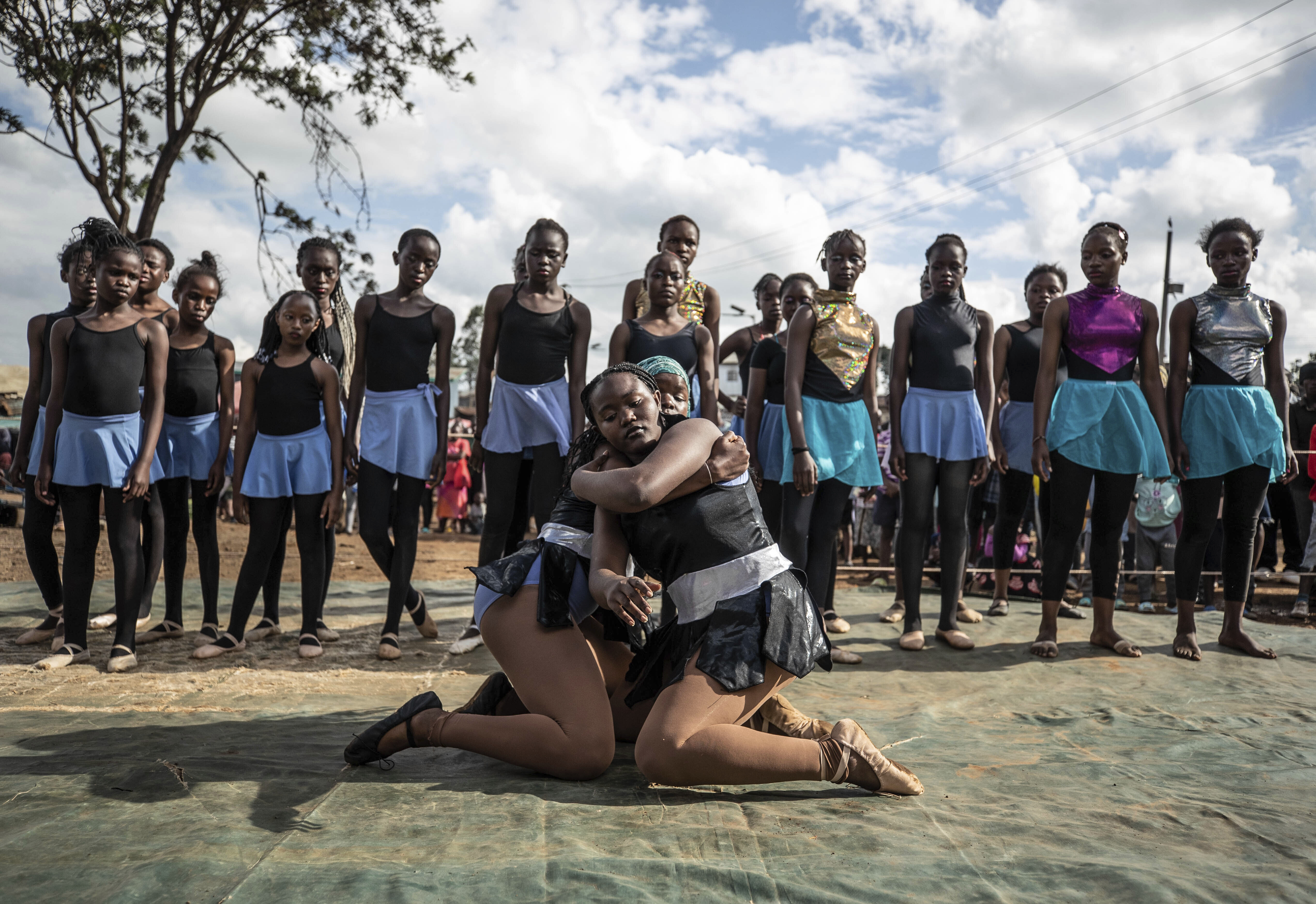 Young dancers practice by the Kenya - Uganda railway line