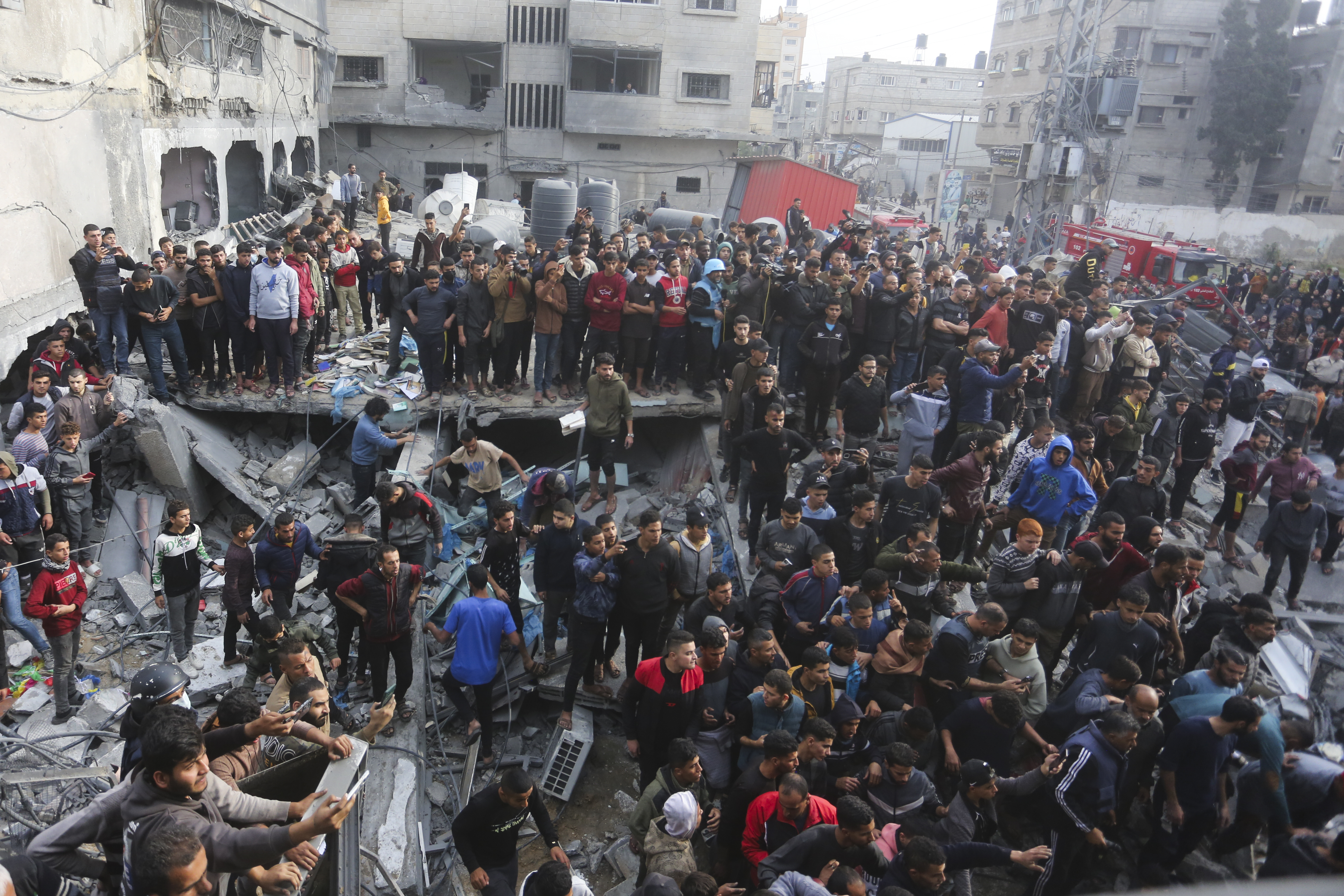 Palestinians look at the destruction after an Israeli strike in Rafah, Gaza Strip.