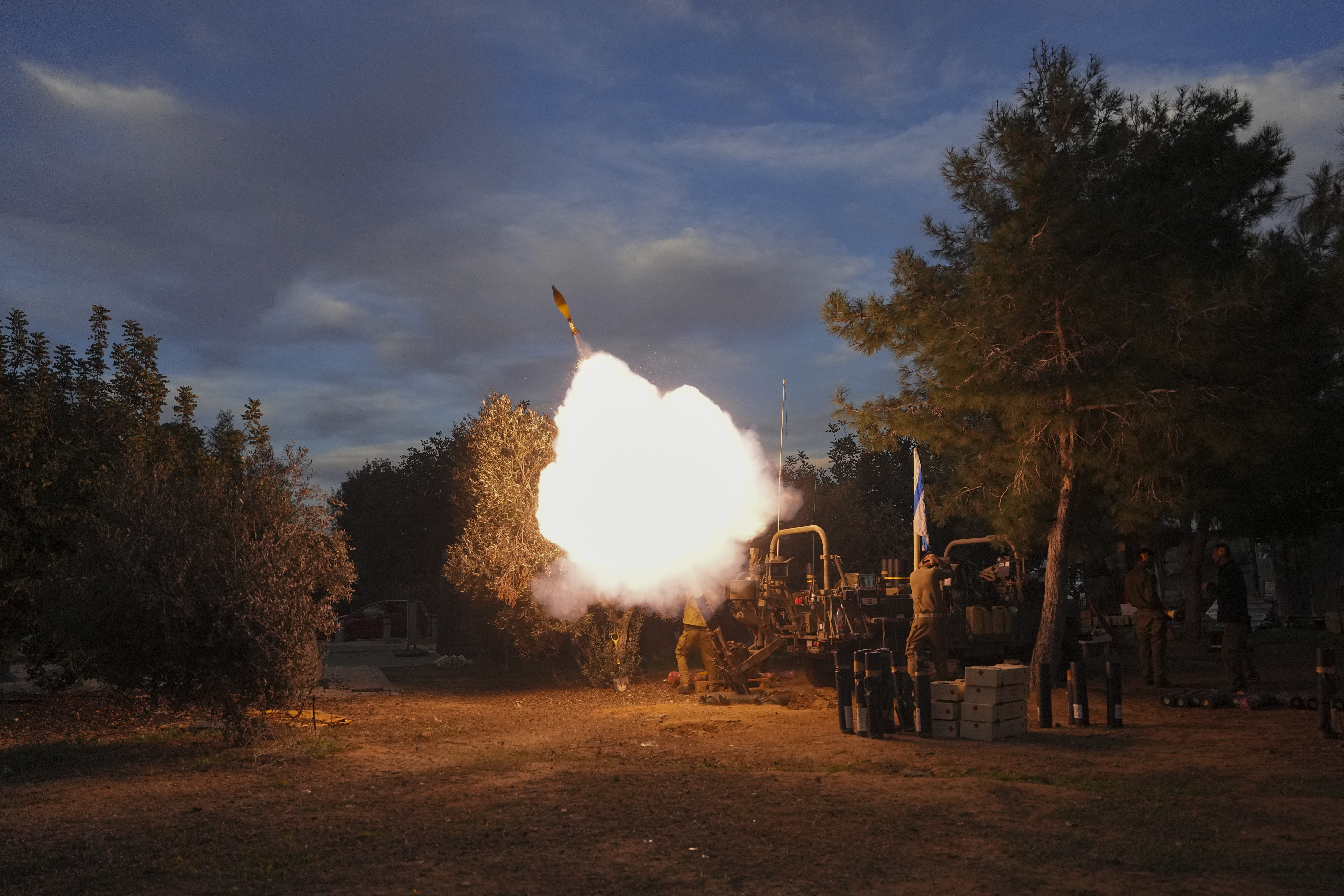 Israeli soldiers fire mortars from southern Israel towards the Gaza Strip, in a position near the Israel-Gaza border.