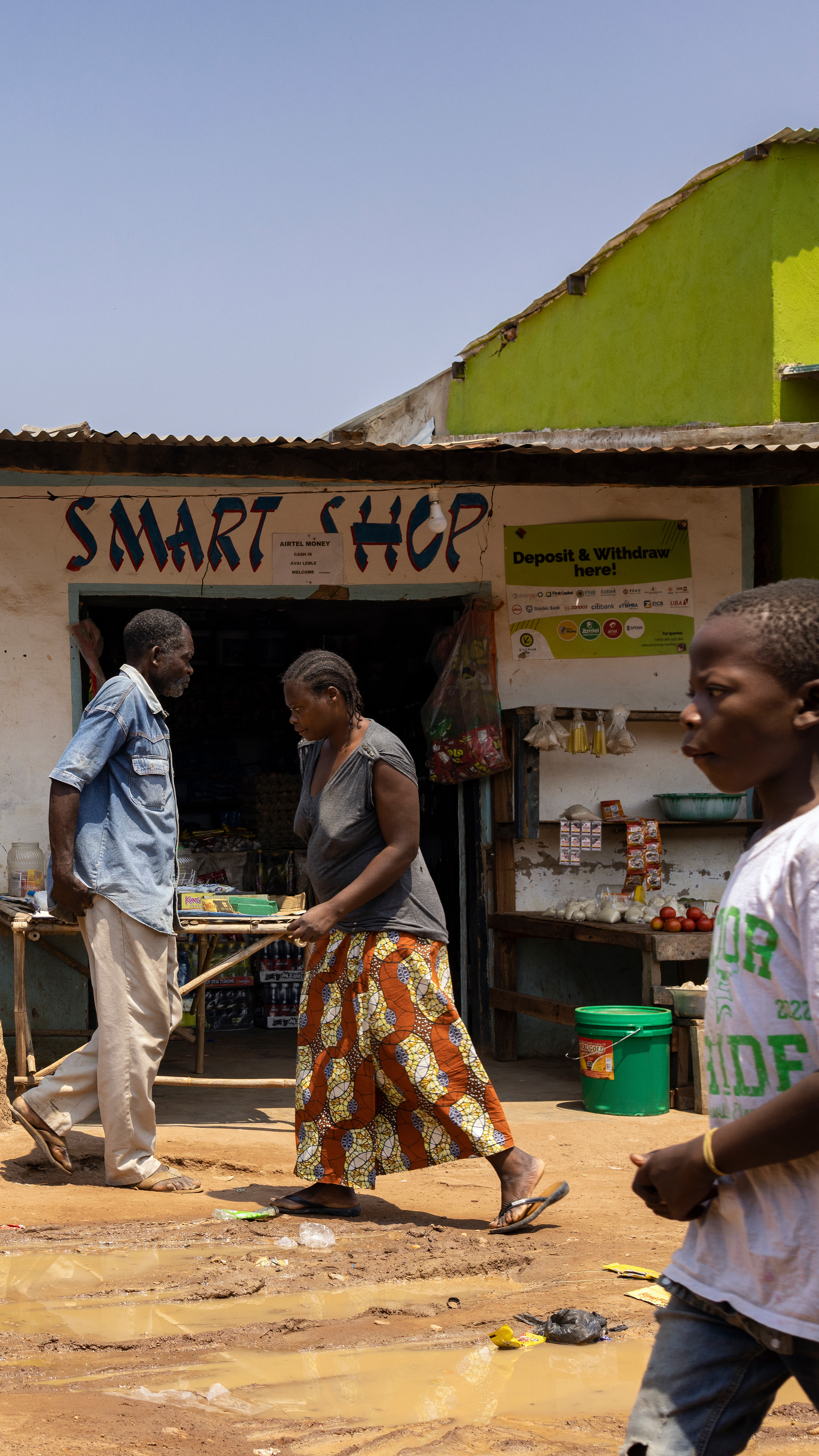People walk in a market in Zambia