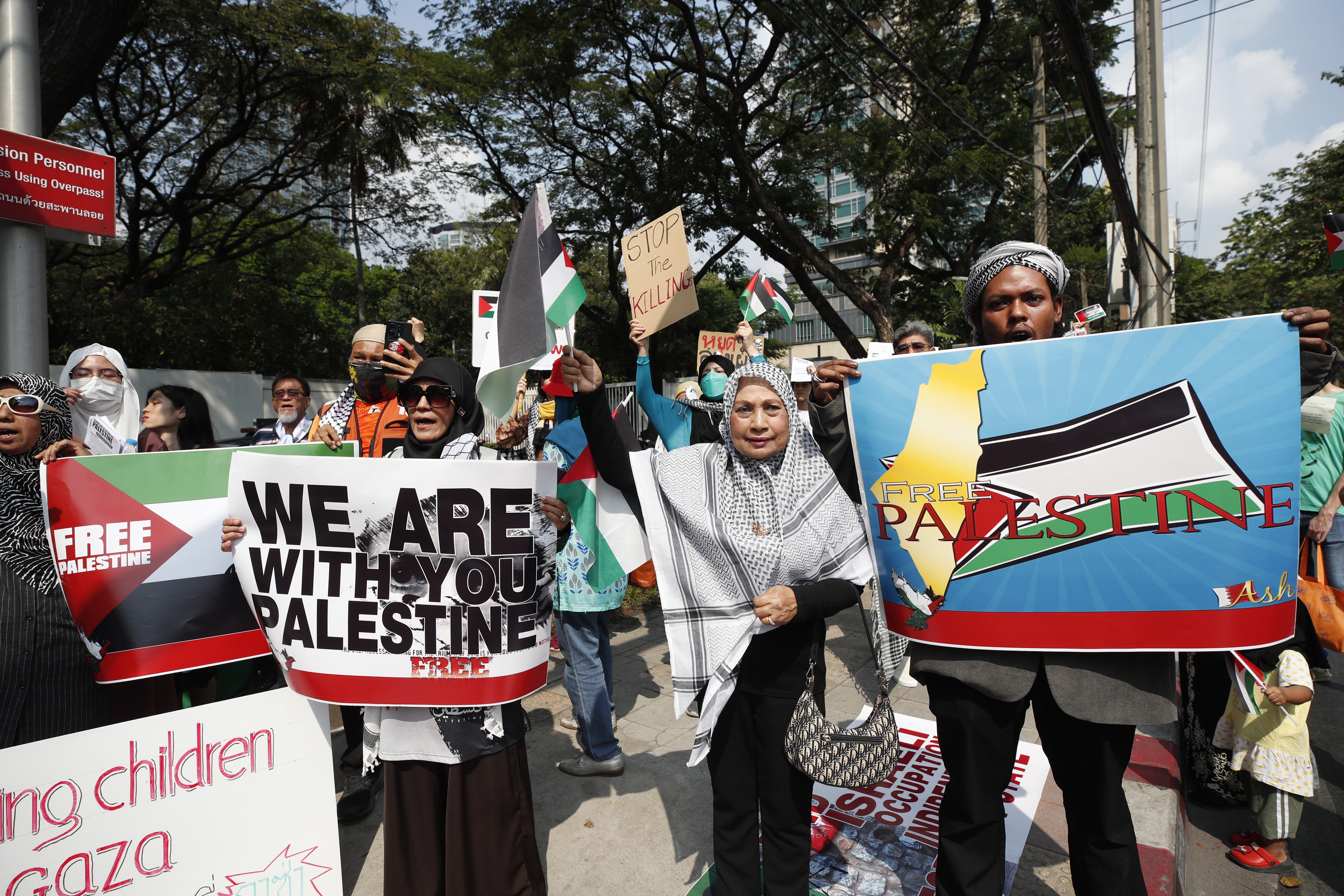 Thai-Muslim demonstrators shout slogans and hold placards during a protest calling for a permanent ceasefire in the Gaza Strip to mark the Global Day of Action for Gaza at the US embassy in Bangkok