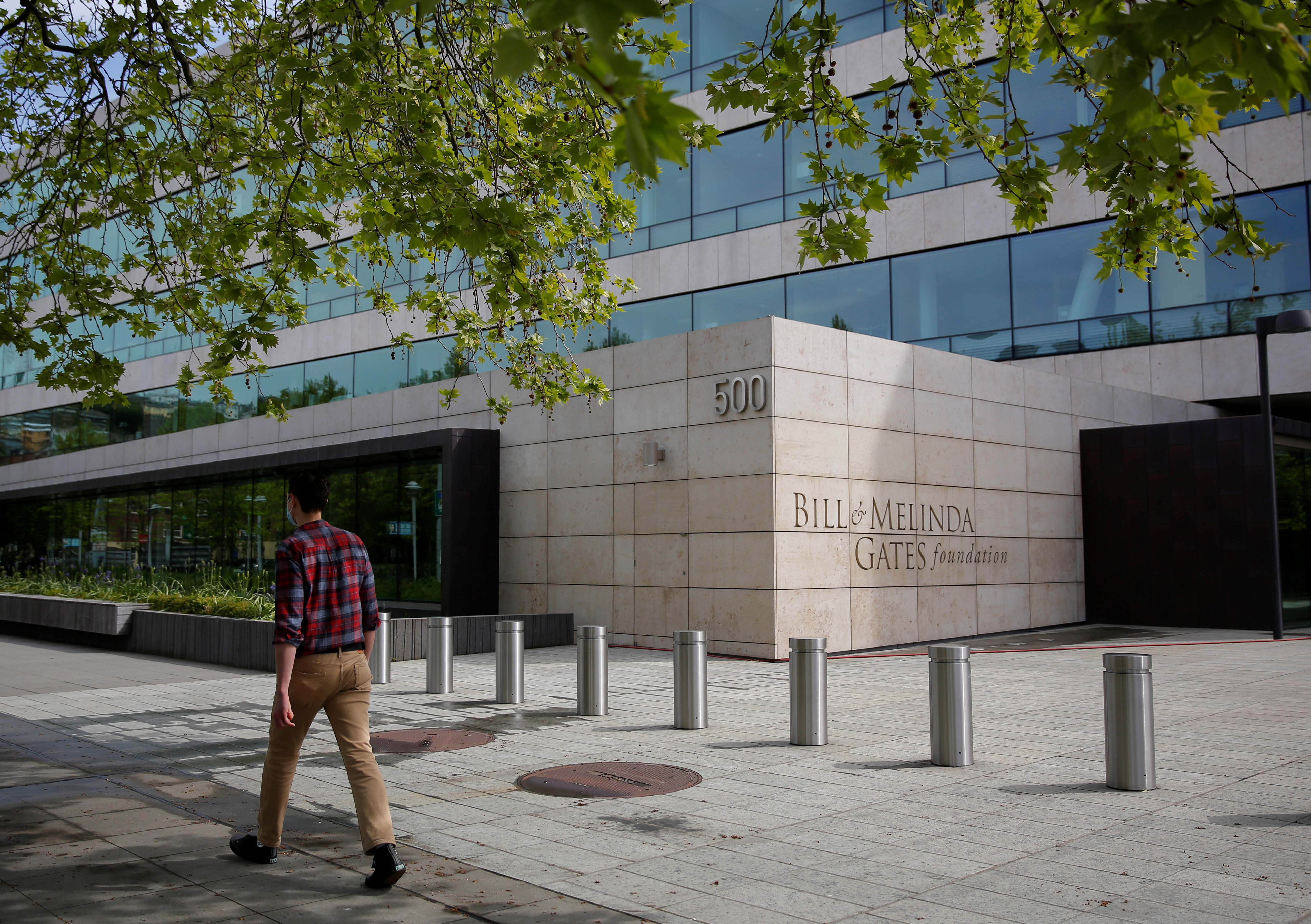 A pedestrian walks by the Bill &amp; Melinda Gates Foundation in Seattle, Washington, U.S. May 5, 2021. REUTERS/Lindsey Wasson