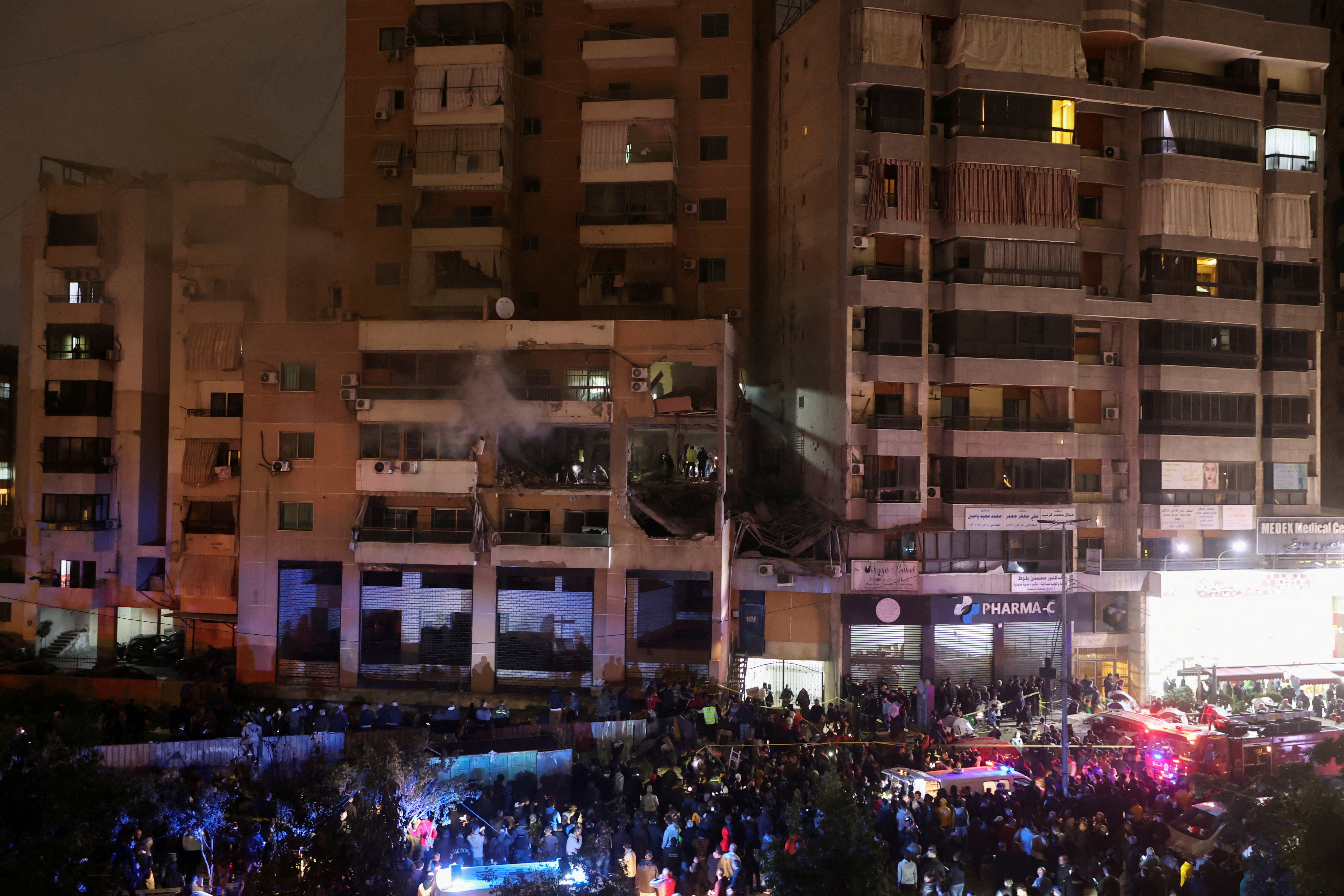 People gather near a damaged site following an explosion, in what security sources say is an Israeli drone strike, at the Beirut suburb of Dahiyeh, Lebanon January 2, 2024