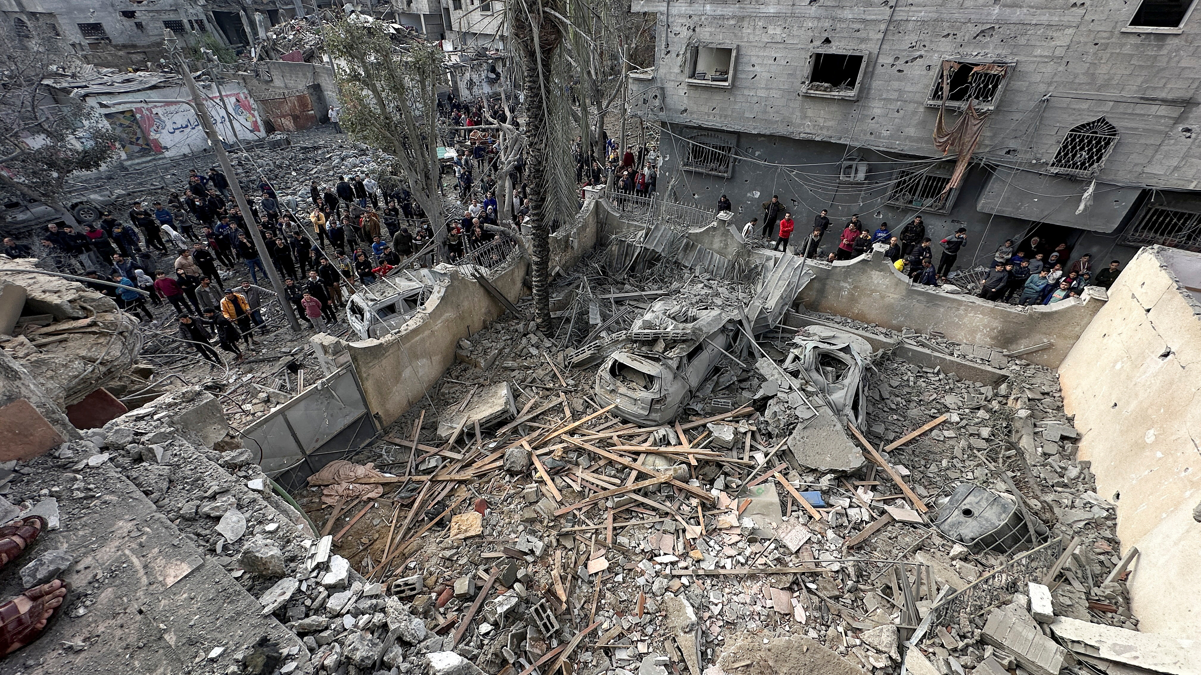 Palestinians inspect the site of an Israeli strike on a house, amid the ongoing conflict between Israel and the Palestinian Islamist group Hamas, in Jabalia in the northern Gaza Strip, January 3