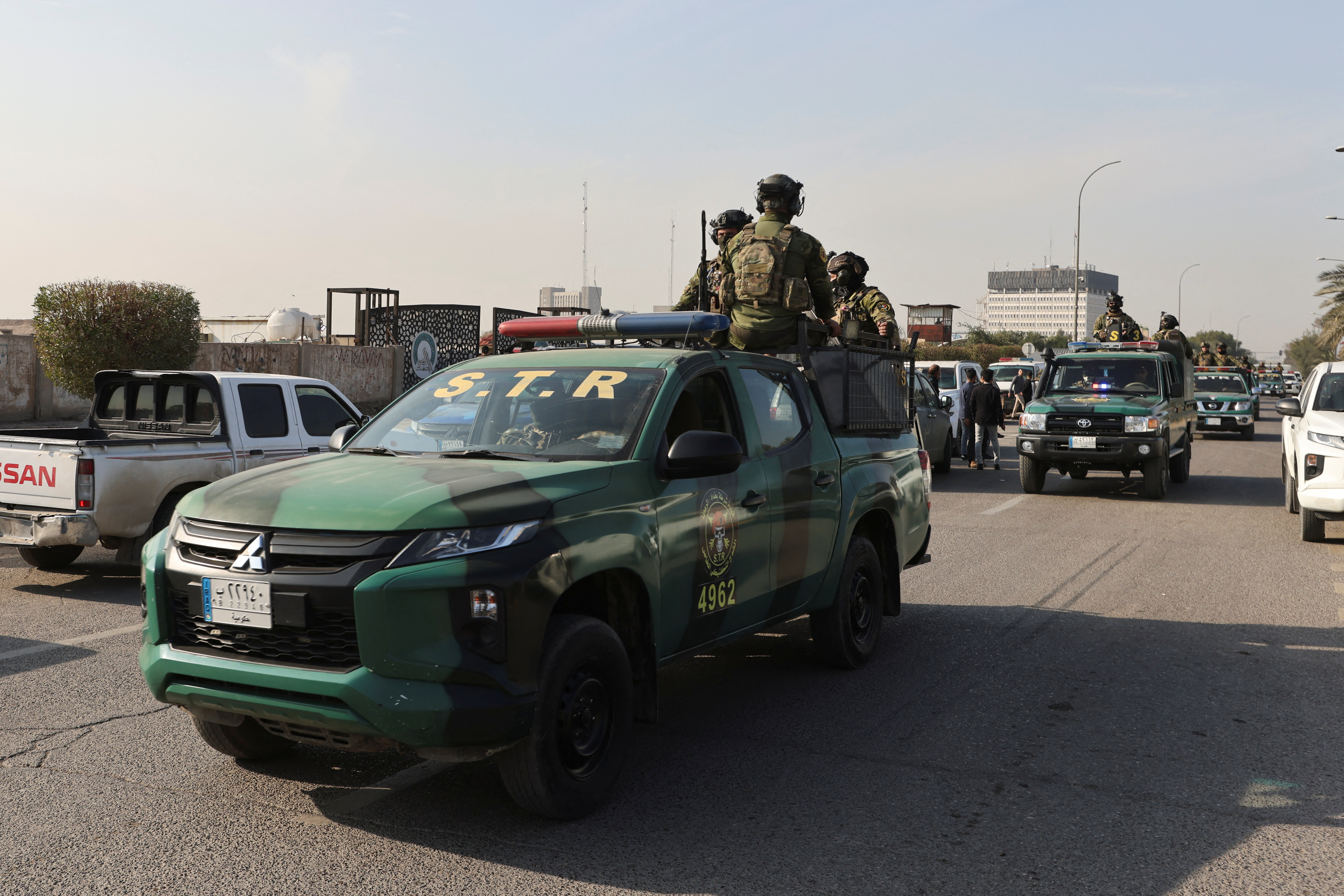 Iraqi security forces on patrol after a drone attack on an Iran-backed paramilitary group's headquarters in Baghdad, January 4, 2024
