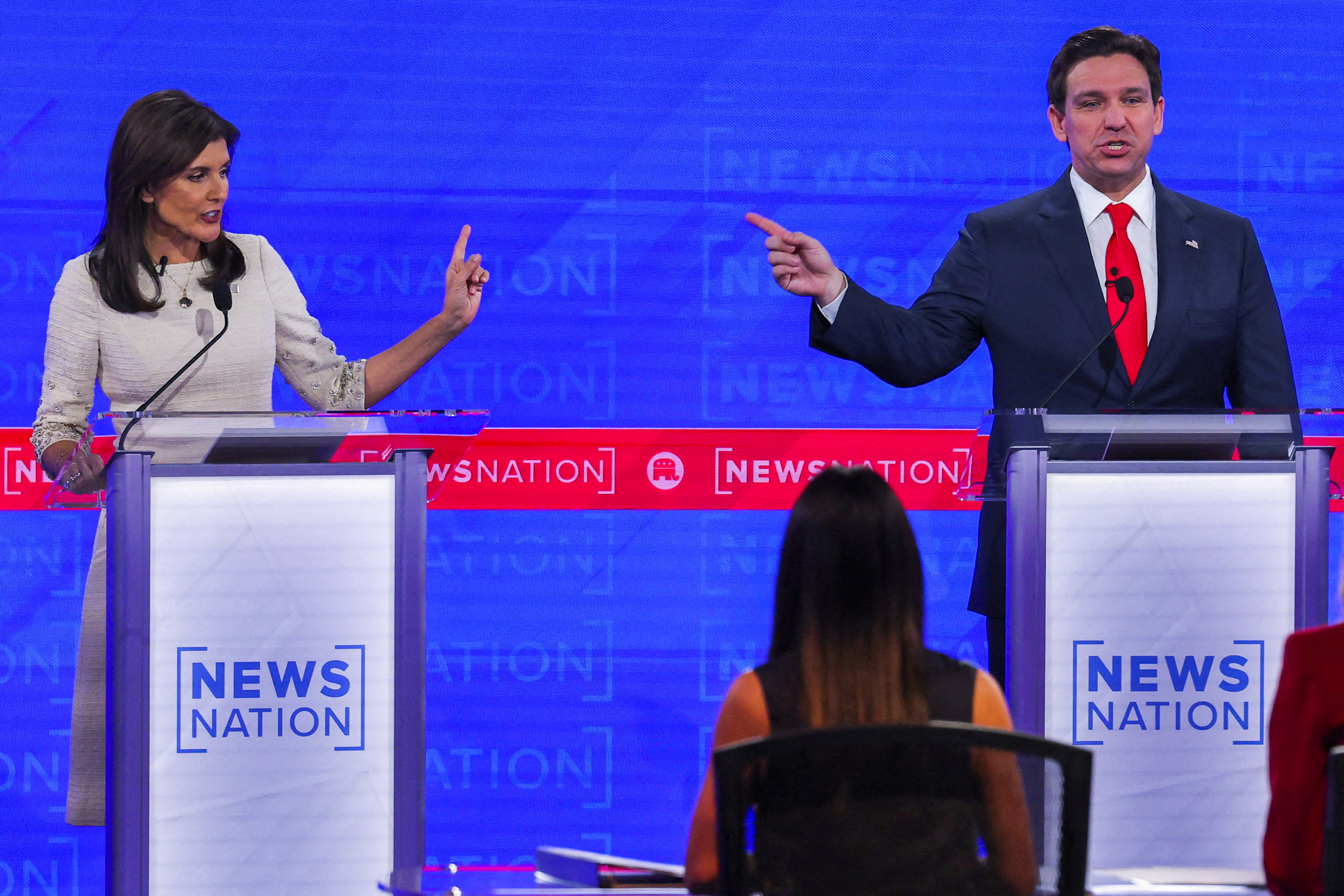 Nikki Haley holds up a finger and Ron DeSantis points at her during a heated exchange during a Republican 2024 debate