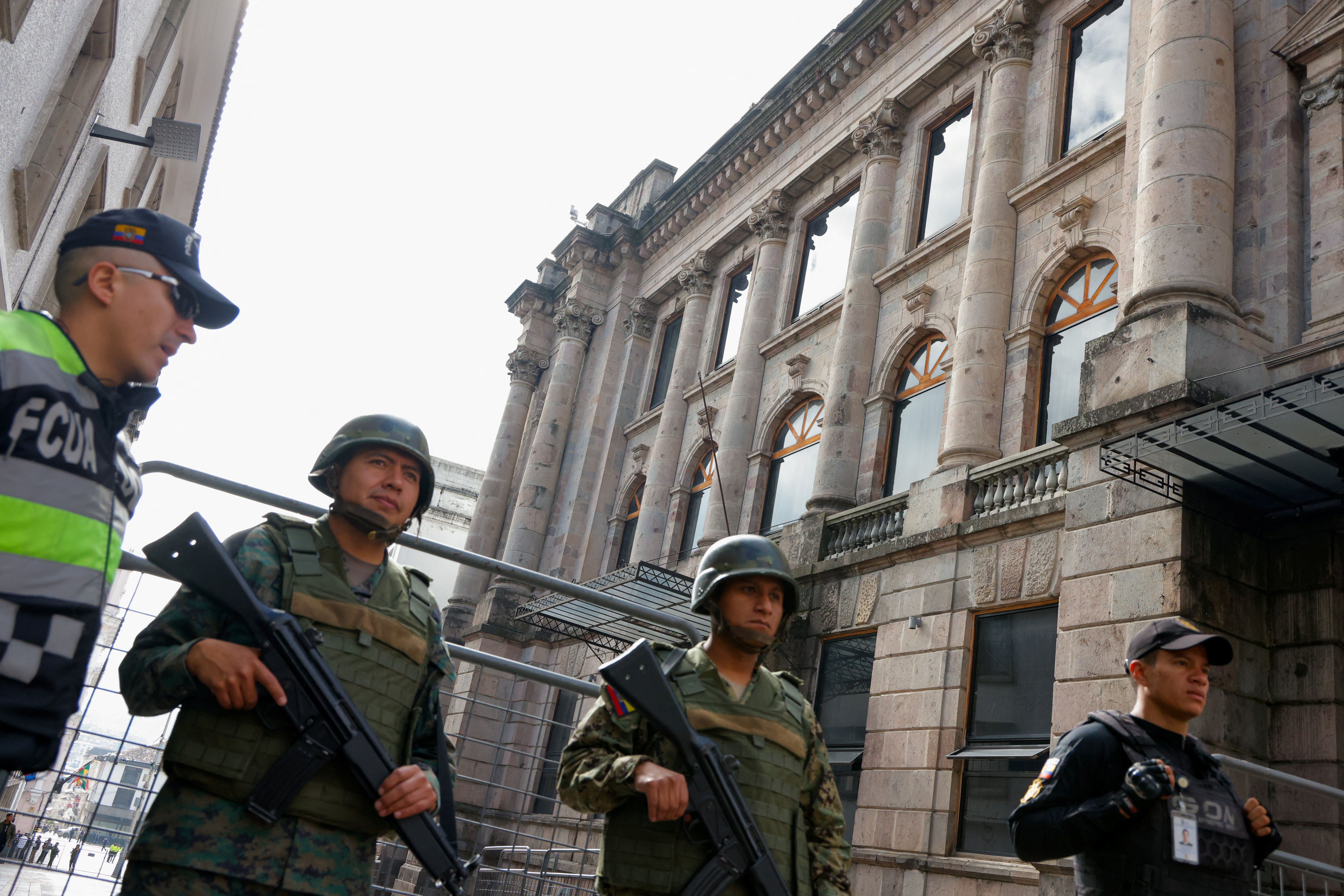 Soldiers and police officers stand guard in Ecuador