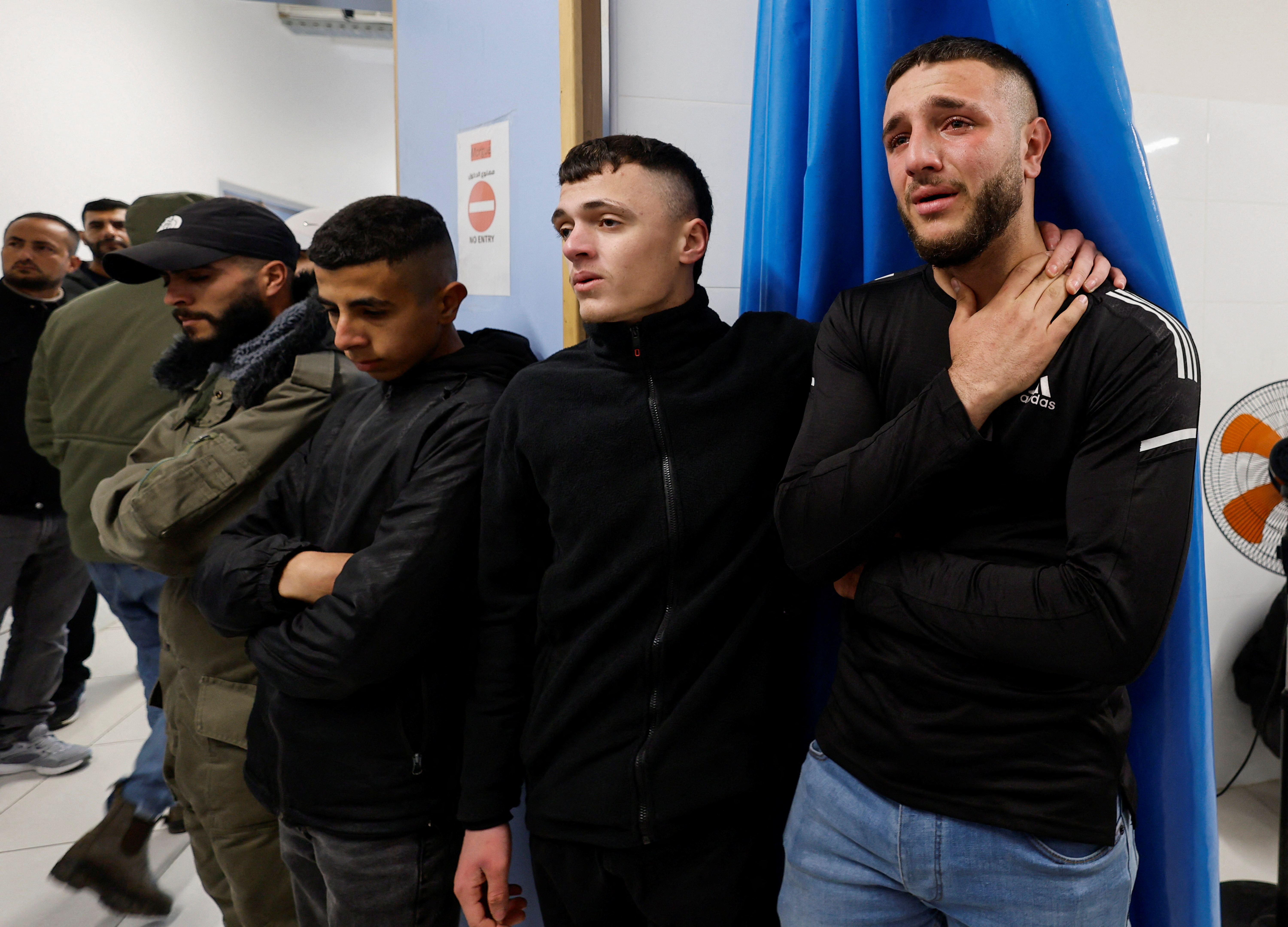 Relatives react near the body of 22-year old Palestinian Mohammed Abu Sba'a who was killed by Israeli troops, in a Hospital in Dura near Hebron