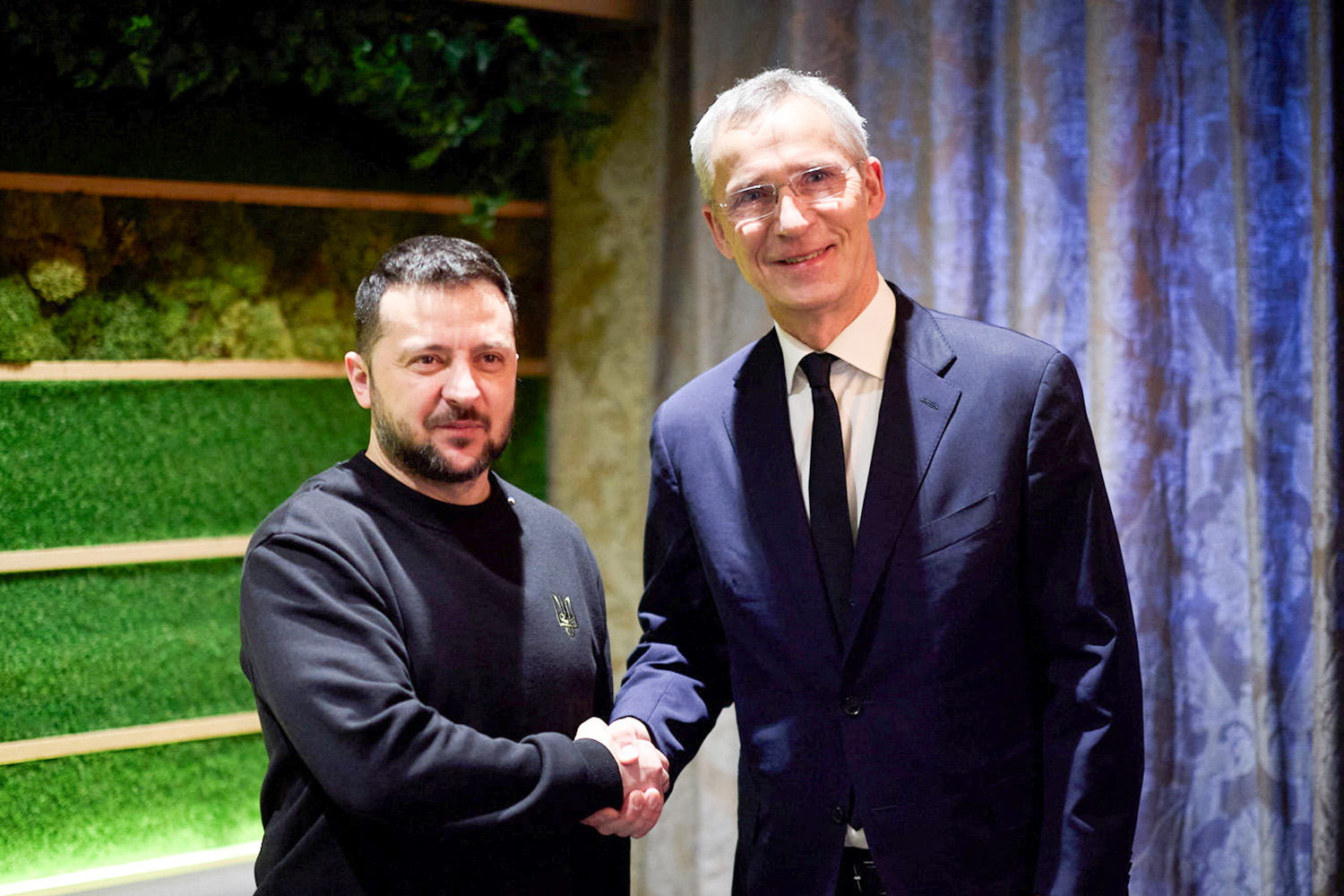 Ukraine's President Volodymyr Zelenskiy and NATO Secretary General Jens Stoltenberg shake hands and pose for a picture before their meeting at the World Economic Forum (WEF) in Davos