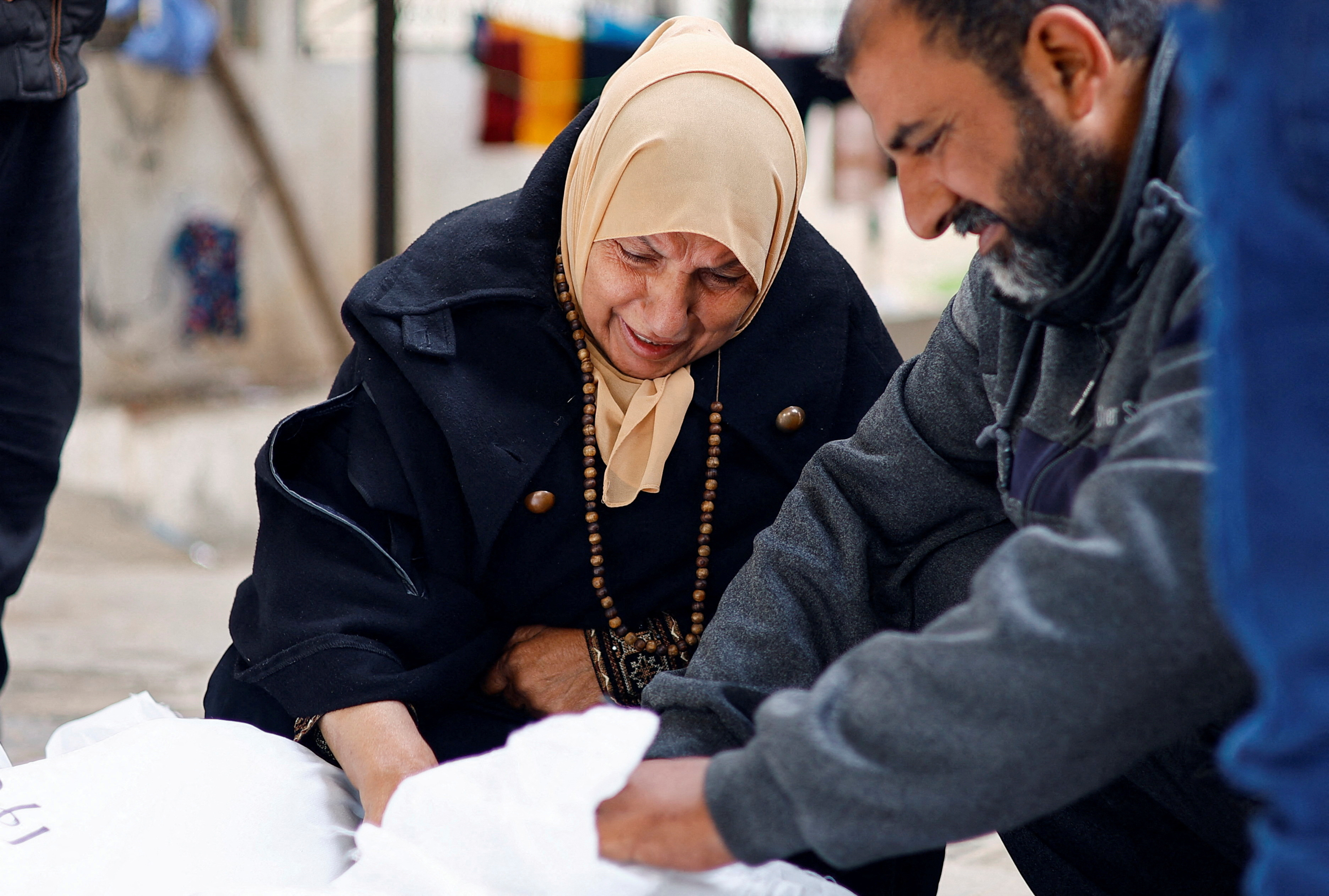 Mourners react next to the body of a relative, amid the ongoing conflict between Israel and the Palestinian Islamist group Hamas, in Rafah in the southern Gaza Strip