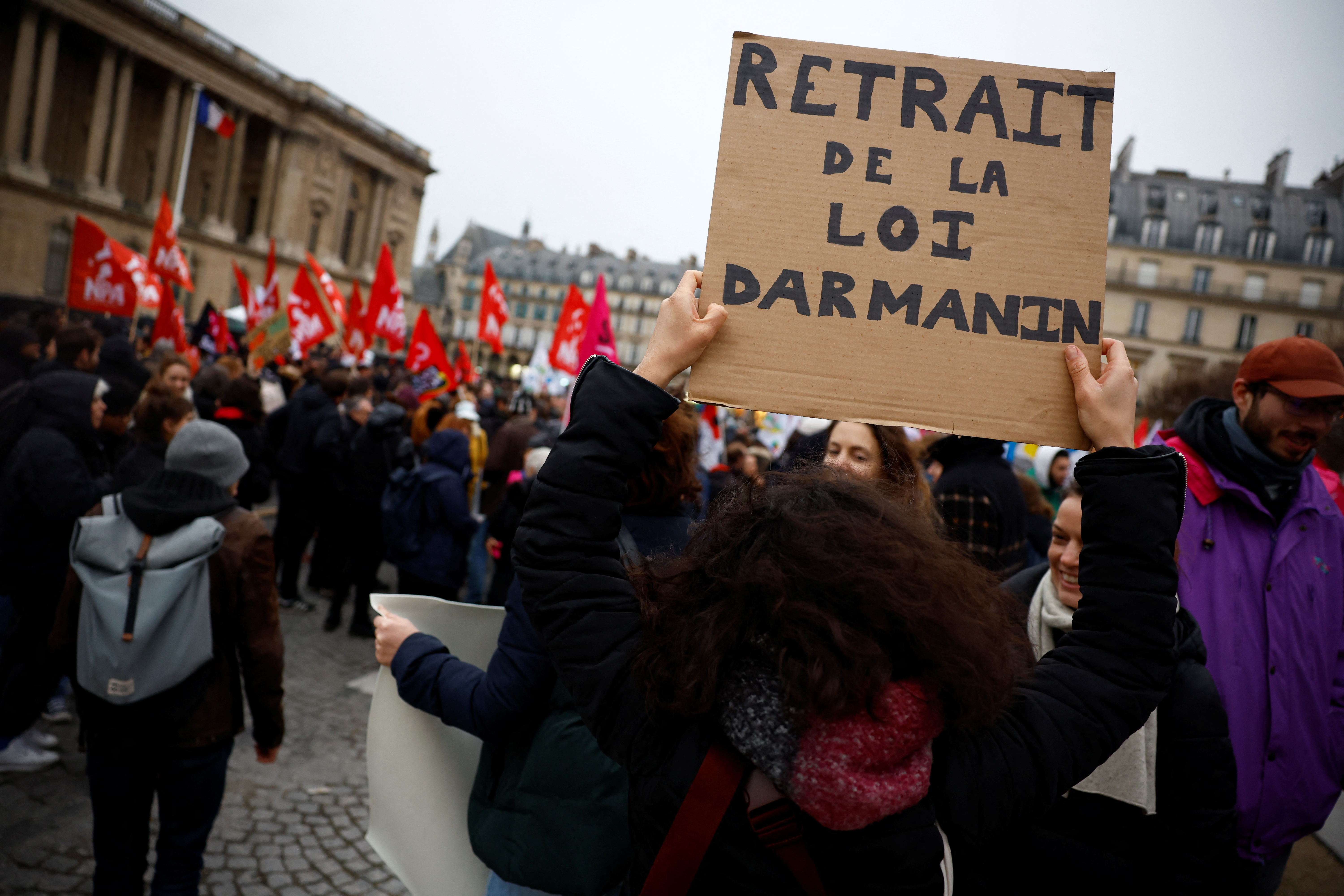 People attend a demonstration against the immigration law, surnamed "Darmanin law",