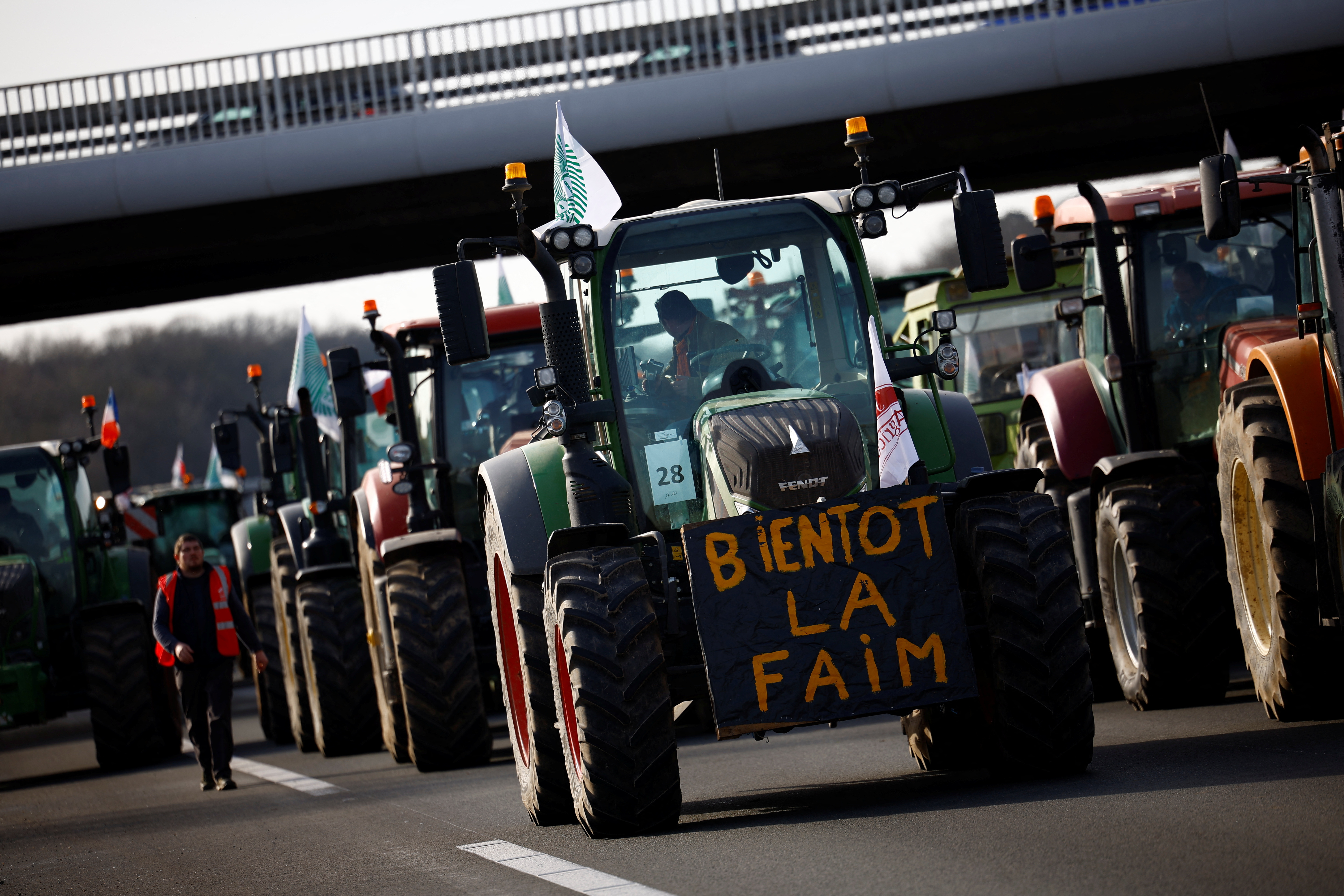 French farmers drive their tractors on a highway as they protest over price pressures, taxes and green regulation, grievances shared by farmers across Europe
