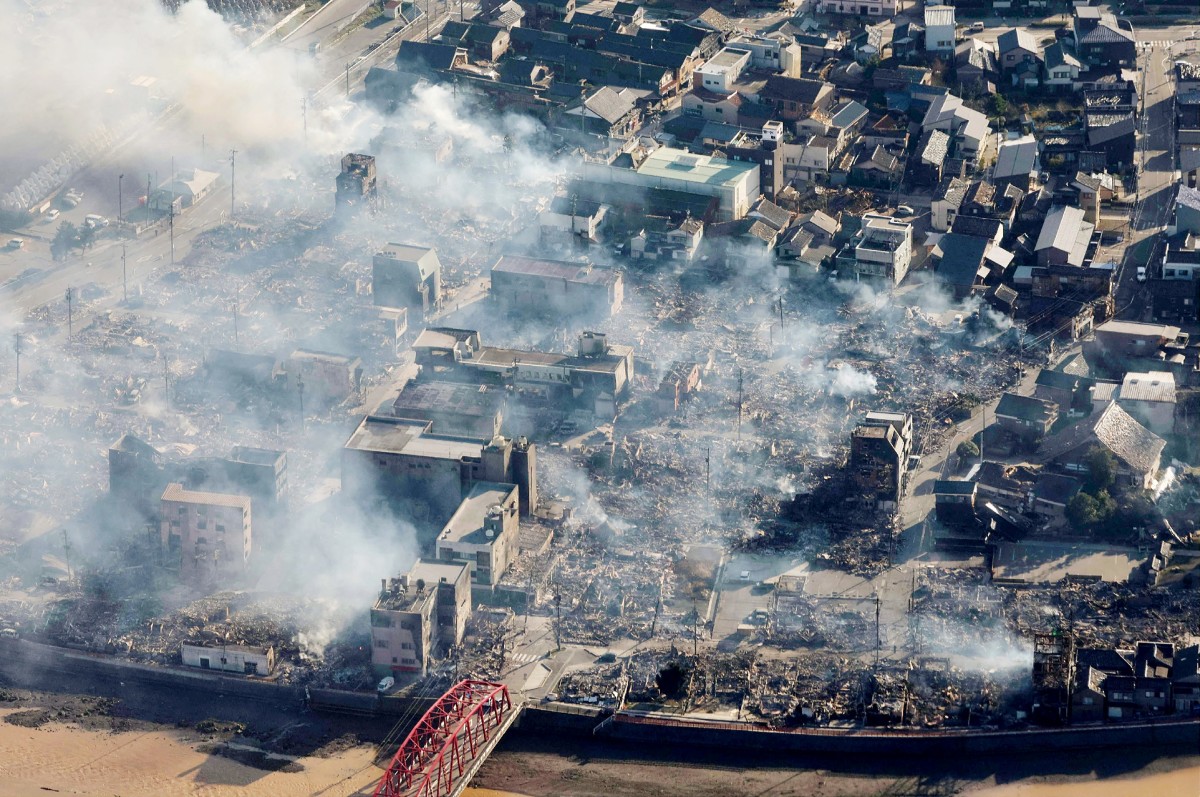This aerial photo provided by Jiji Press shows smoke rising from an area following a large fire in Wajima, Ishikawa prefecture.