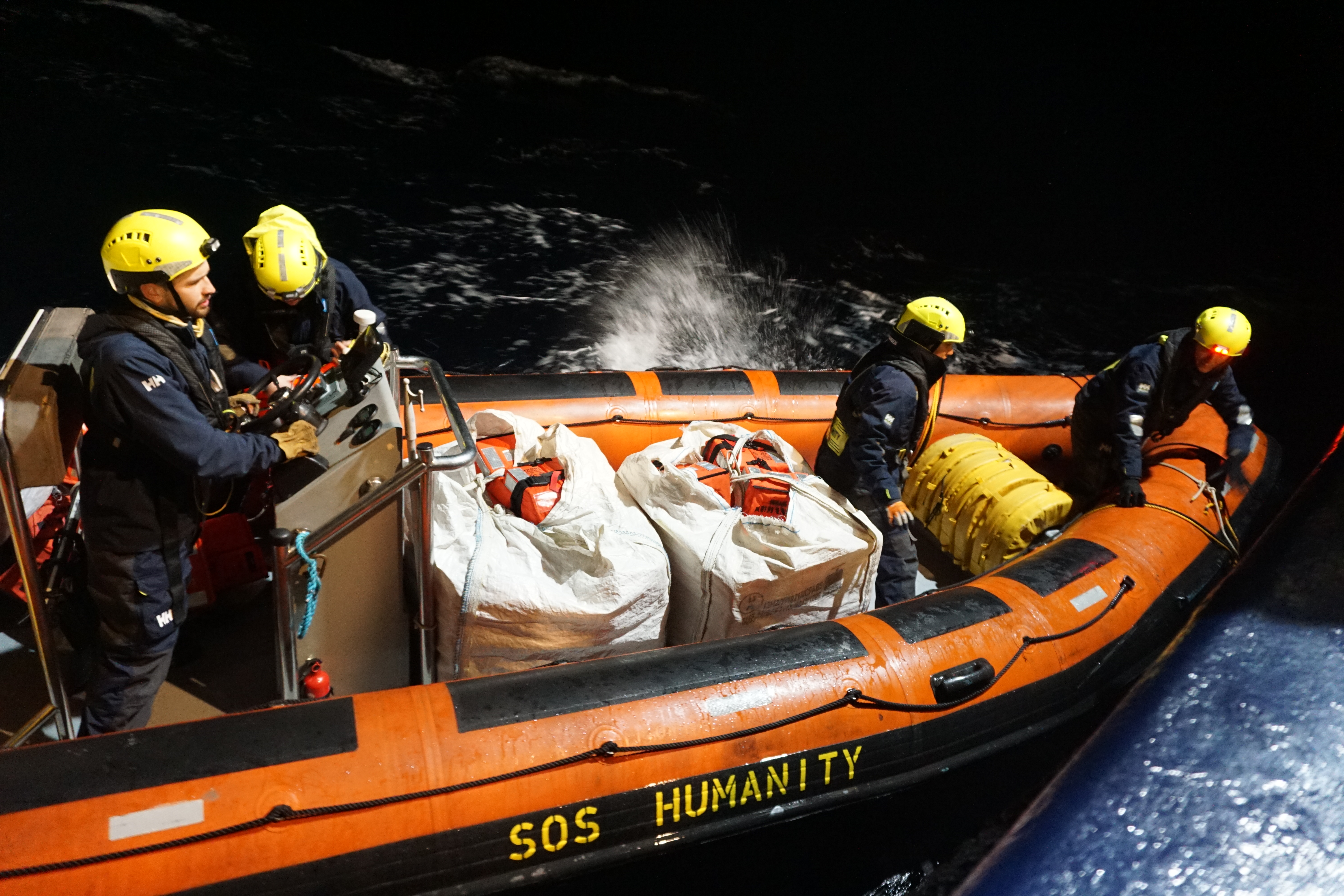 RIBs being launched into the dark sea