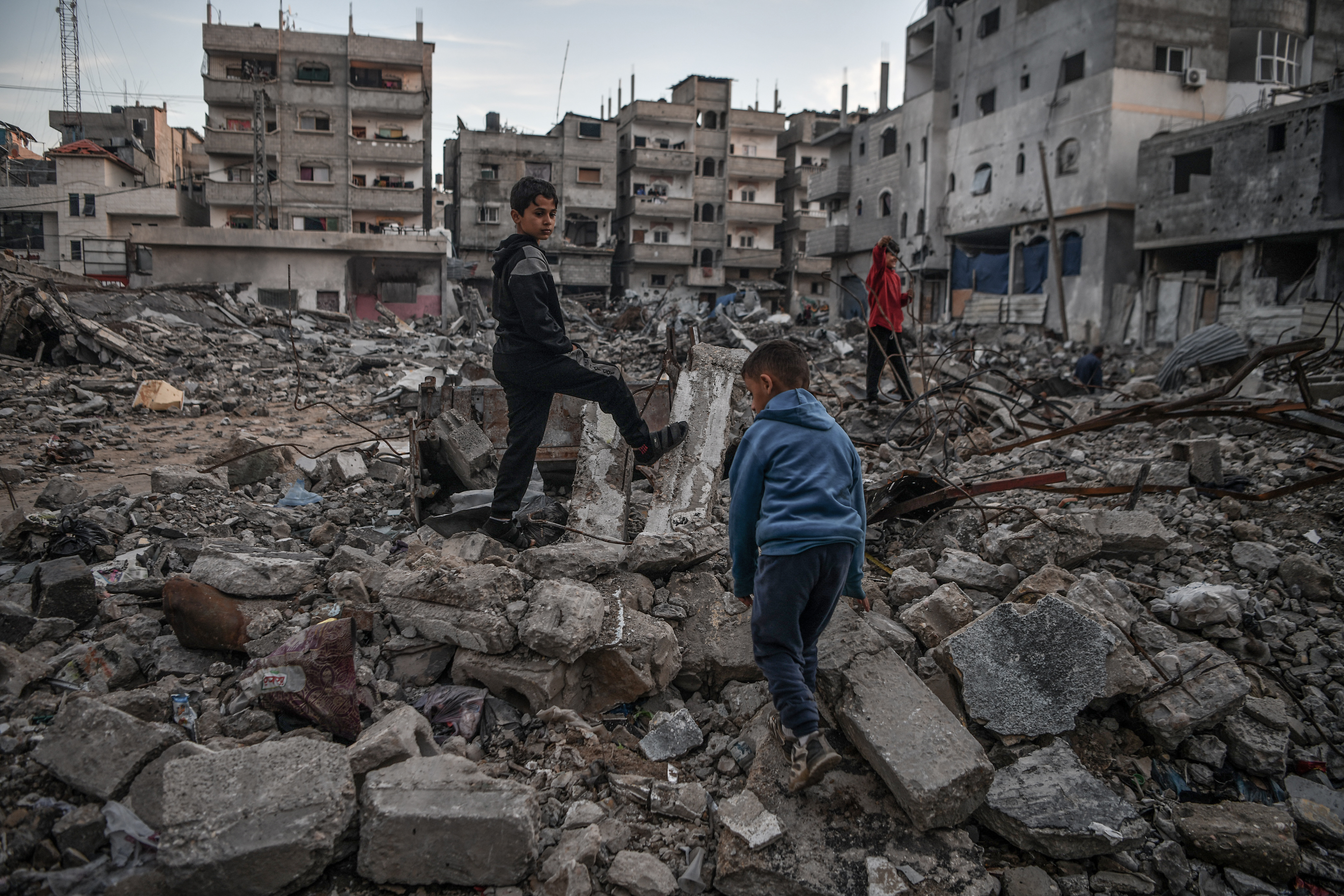 Palestinian boys are seen in the rubble of a building destroyed by an Israeli attack while Israel's attacks continue on Gaza Strip as Palestinians who took refuge in the city of Rafah are trying to continue their daily work even though the attacks continue in Rafah, Gaza on January 03, 2024.