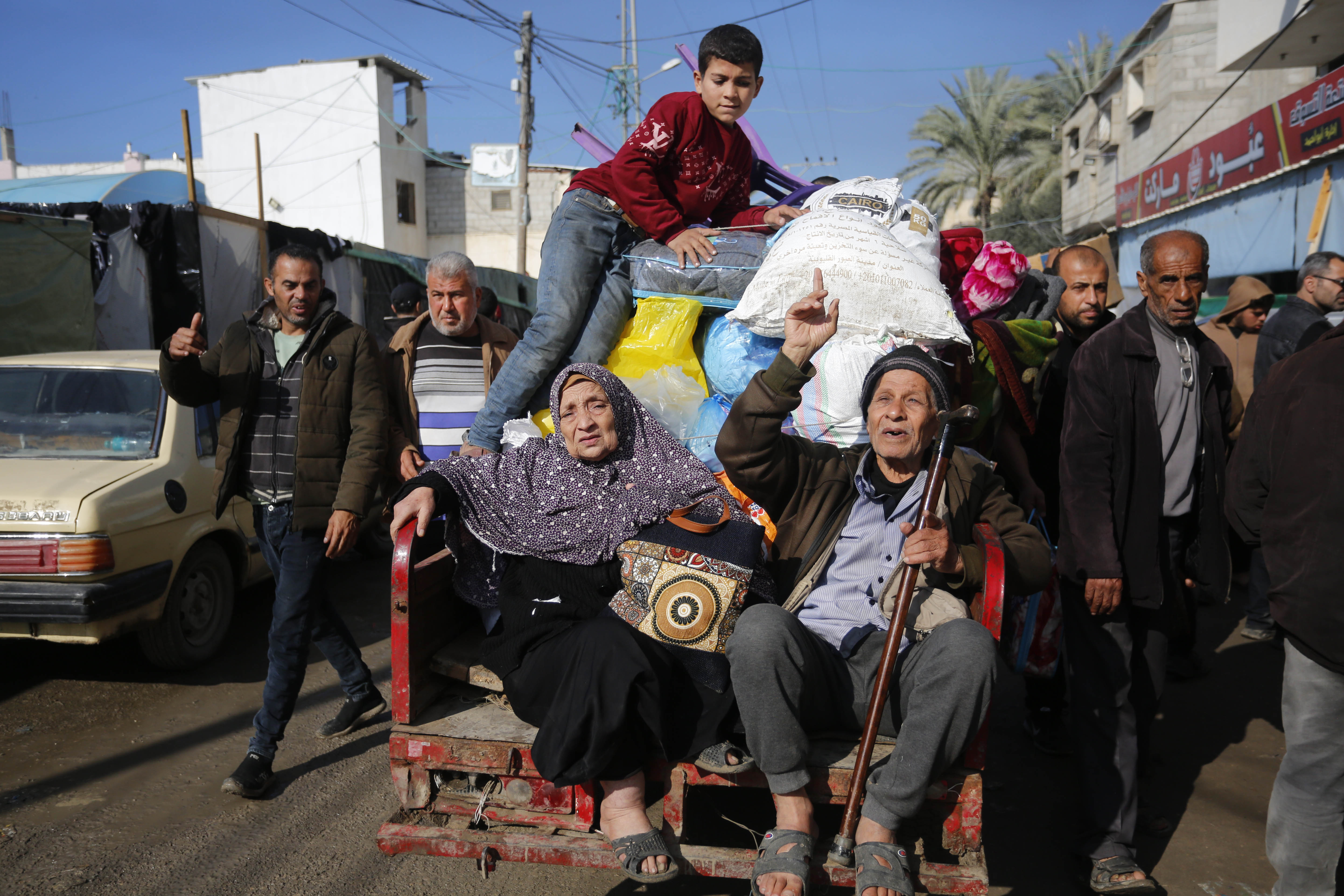 Palestinian citizens carrying their belongings leave their homes in Al-Maghazi refugee camp to seek safer places in the city as Israeli attacks continue in Deir al-Balah, Gaza.