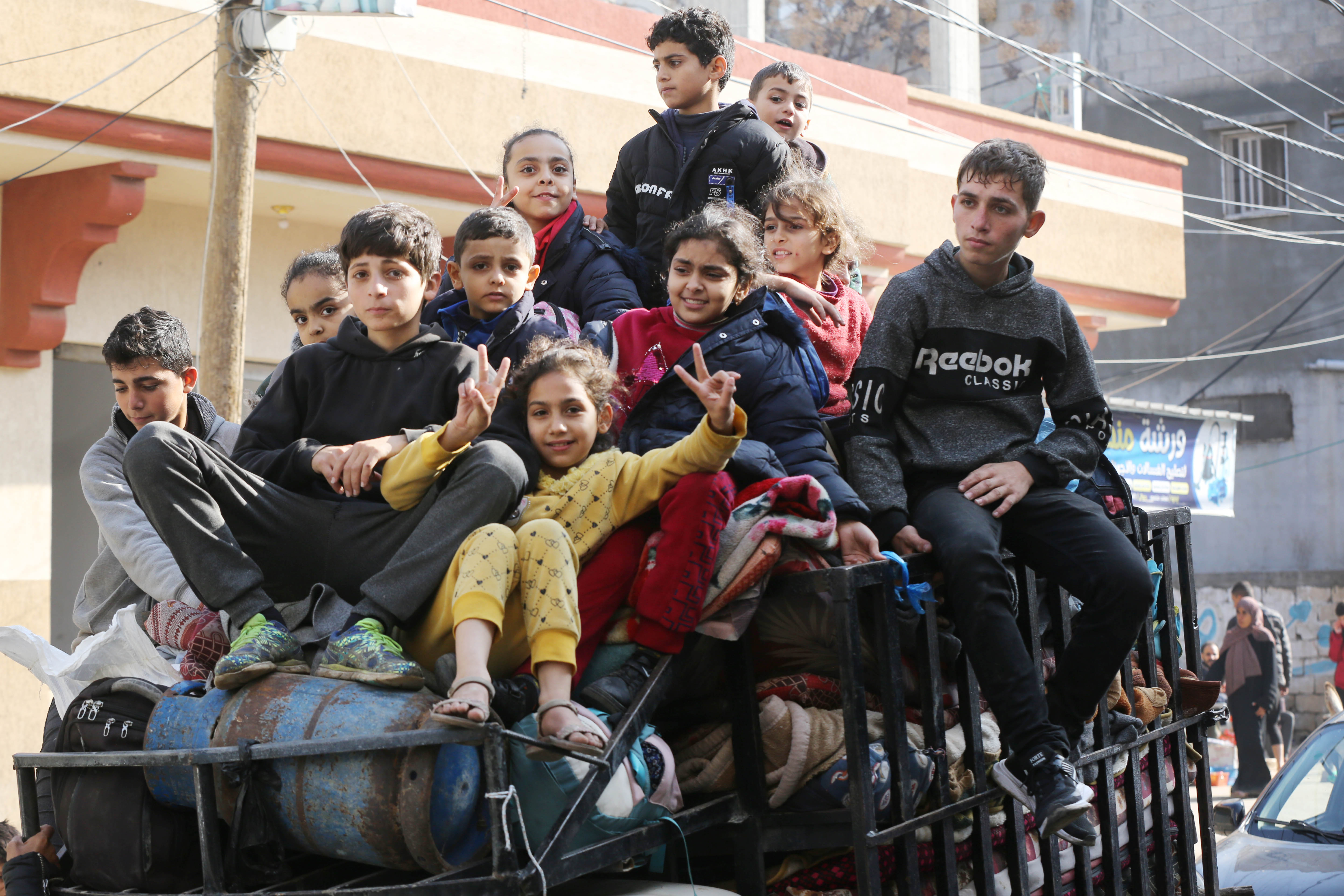 Palestinian citizens carrying their belongings leave their homes in Al-Maghazi refugee camp to seek safer places in the city as Israeli attacks continue in Deir al-Balah, Gaza.