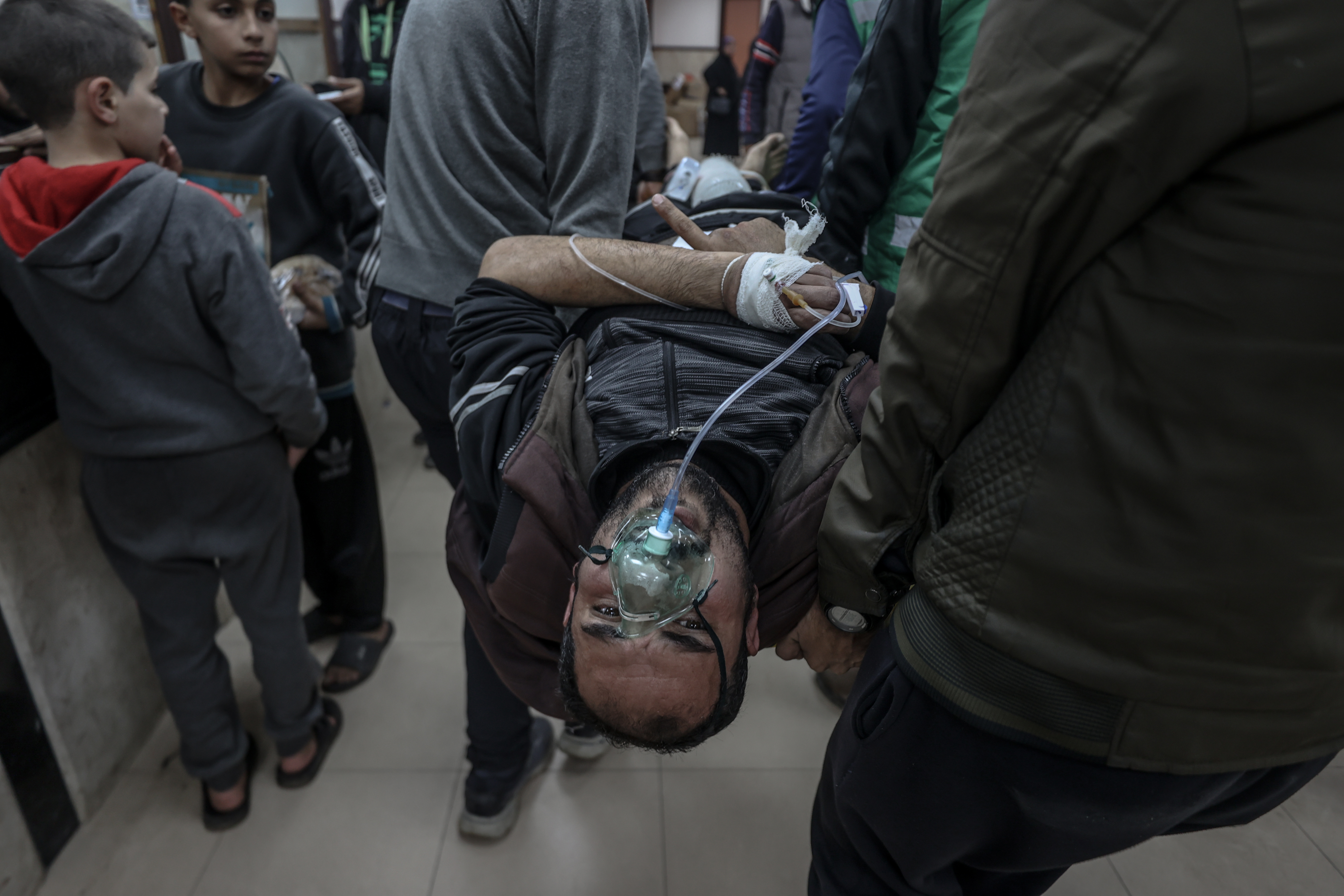 Wounded people, including children, are brought to Al-Aqsa Martyrs Hospital for treatment following the Israeli attacks in Deir al-Balah, Gaza.