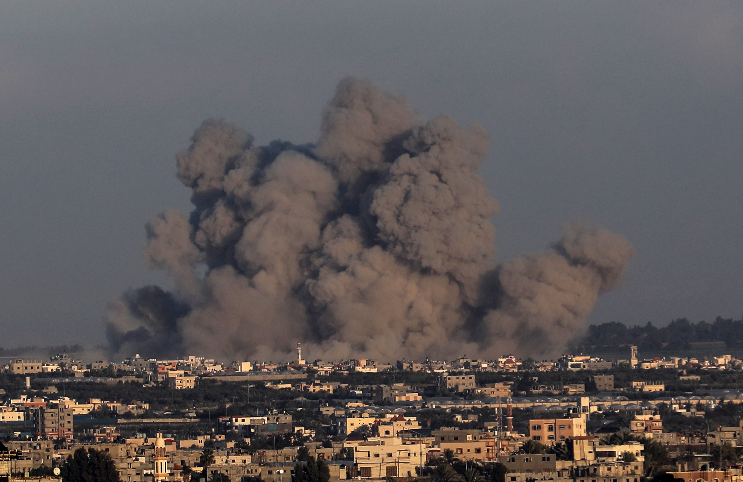 Smoke rises over buildings following the Israeli attacks on Khan Yunis, Gaza on January 04, 2024.