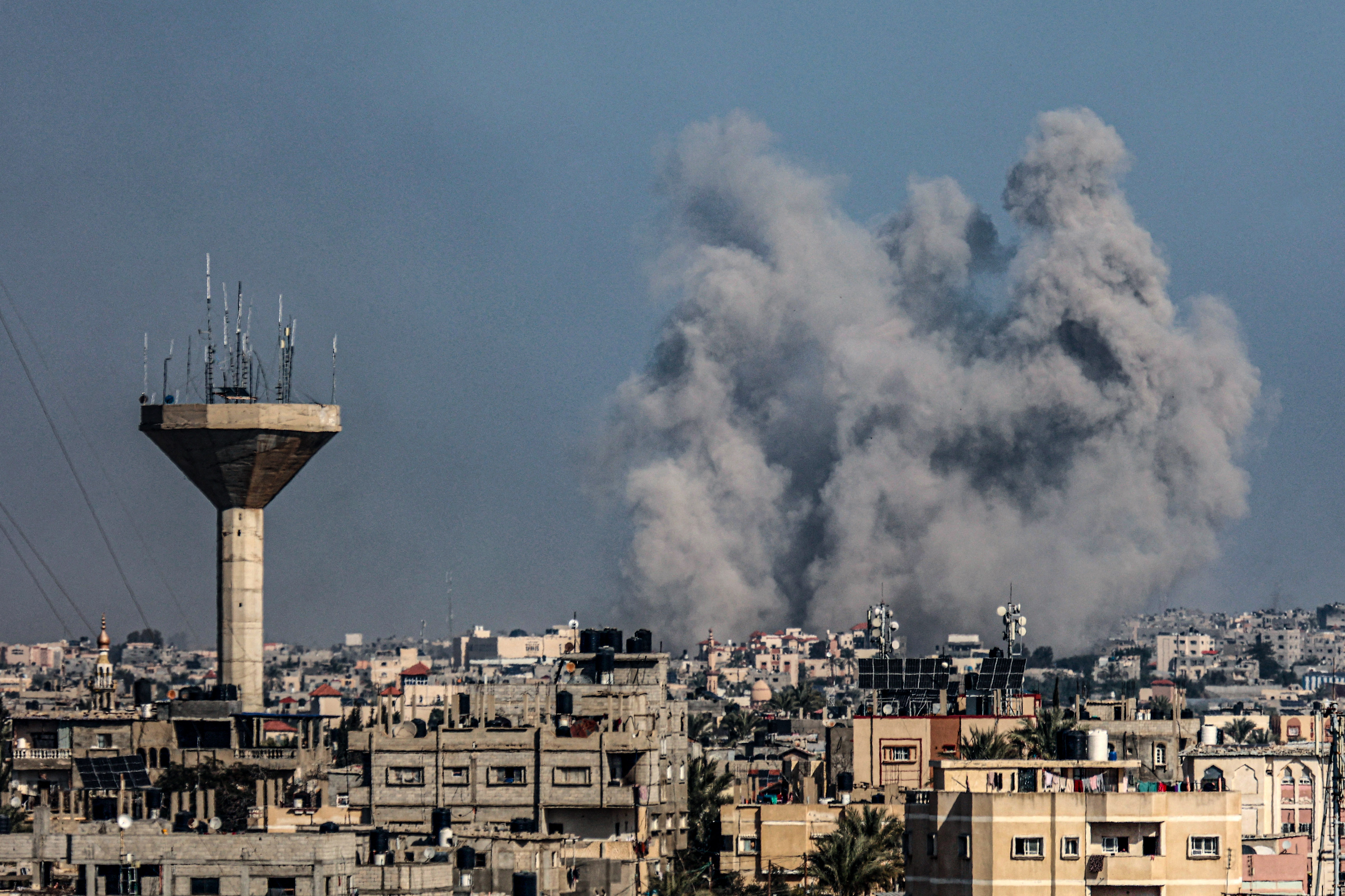 This picture taken on January 18, 2024 from Rafah shows smoke billowing over Khan Yunis in the southern Gaza Strip during Israeli bombardment, amid ongoing battles between Israel and the Palestinian militant group Hamas. (Photo by AFP)